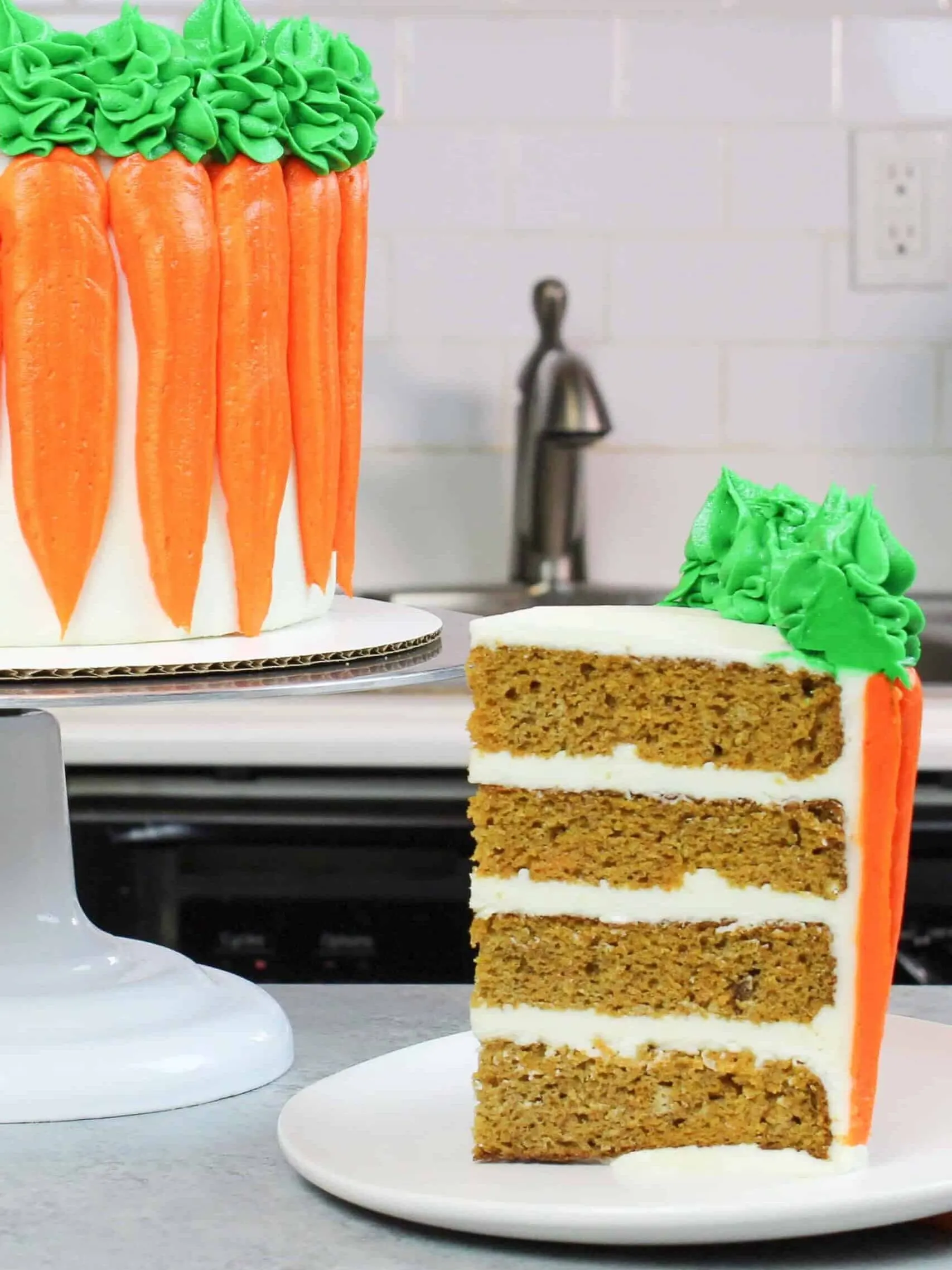 carrot cake slice frosted with cream cheese buttercream, with decorated carrot cake in background