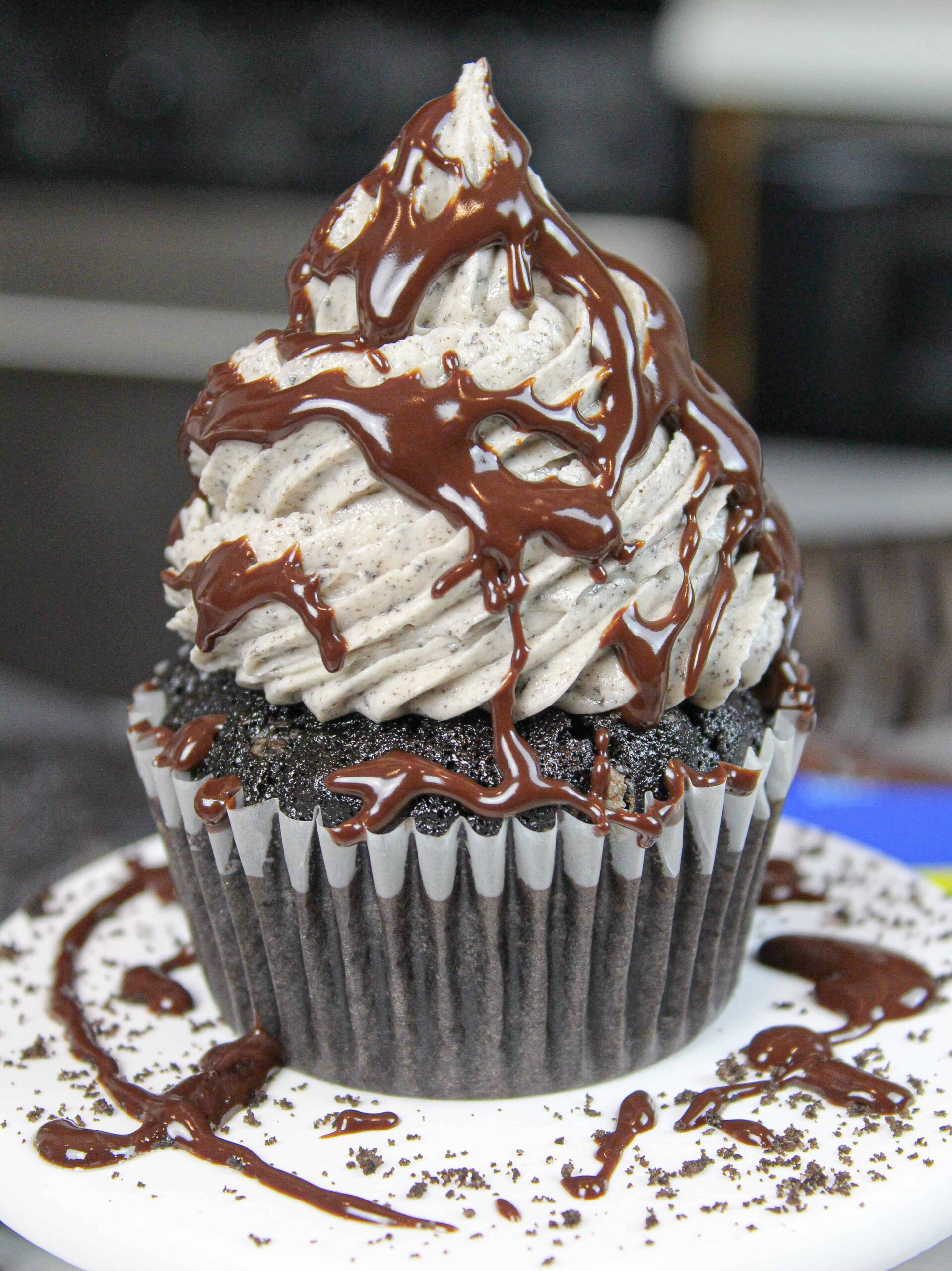 image of oreo cupcake drizzled with chocolate ganache and crushed oreo crumbs