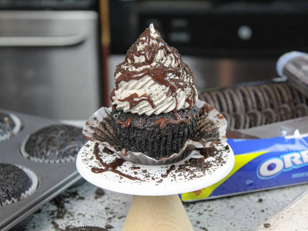 image of oreo cupcake decorated with chocolate ganache and crushed oreos