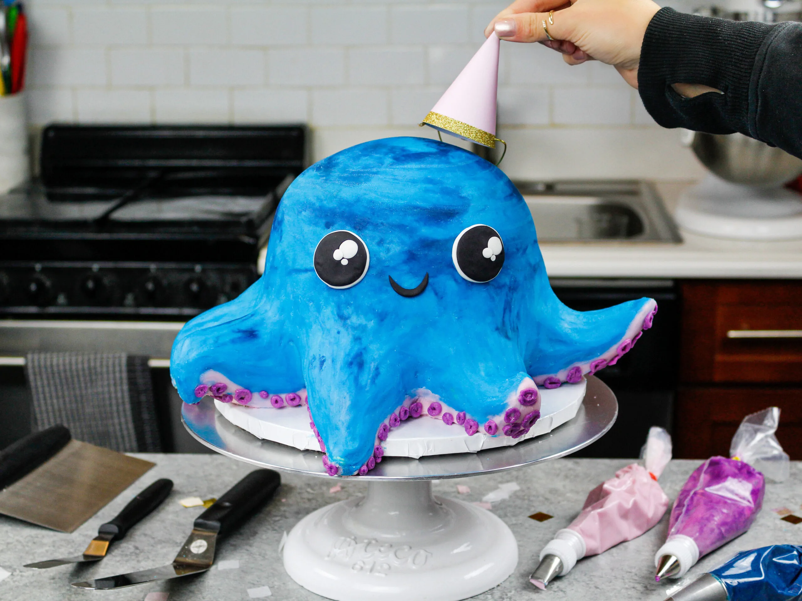 image of an octopus cake made for a birthday party with a party hat