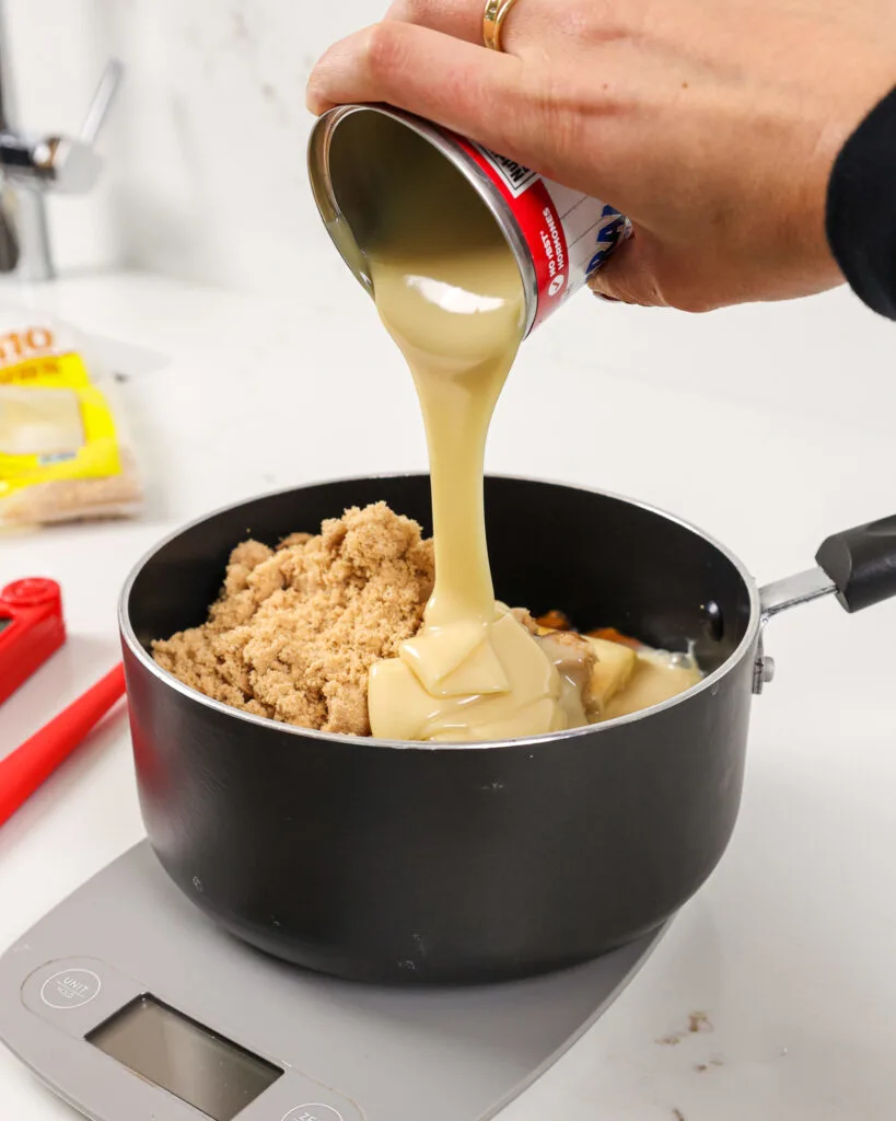 image of sweetened condensed milk being poured into a pot to make a thick caramel filling