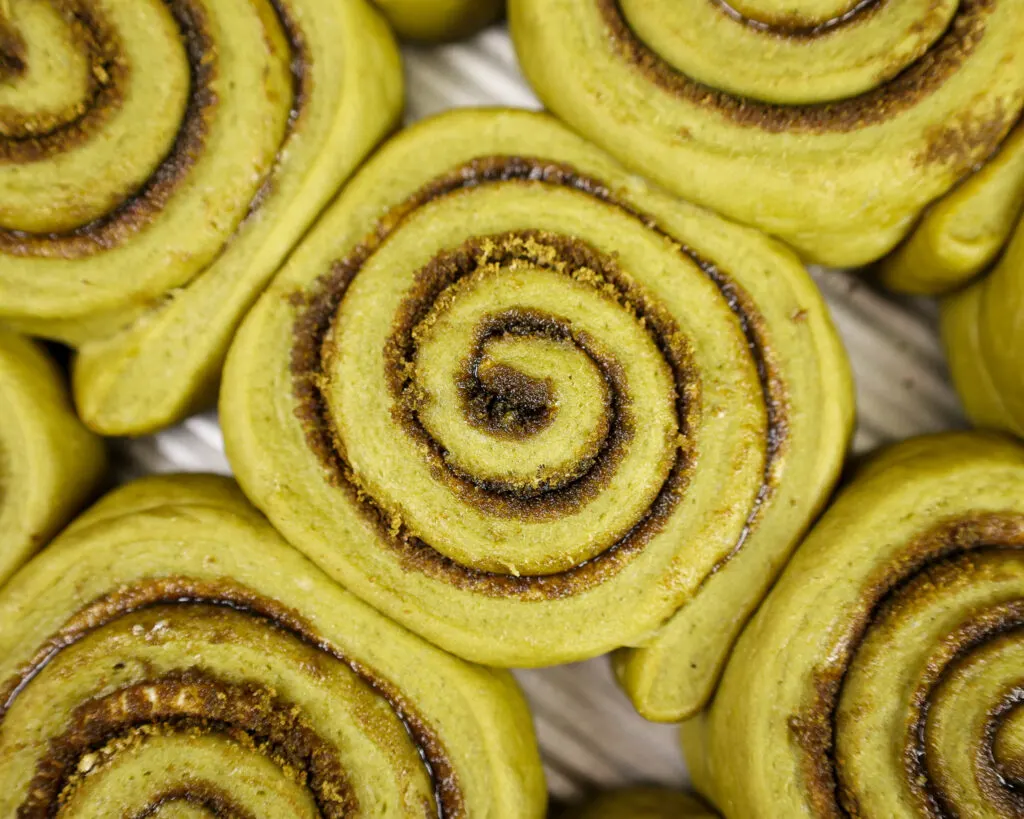image of matcha cinnamon rolls that have been proofed and are ready to be baked