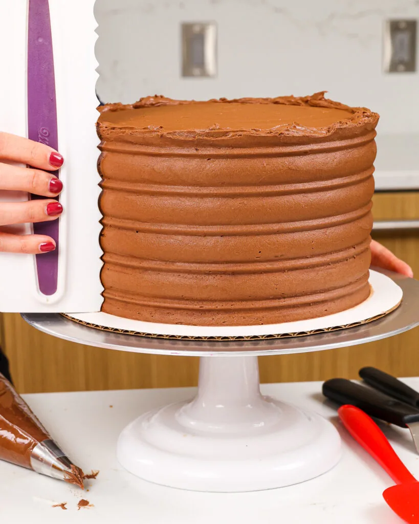 image of a twix cake being decorated with an icing comb