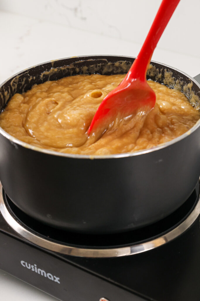 image of thick caramel filling being cooked until it reaches 230 degrees Fahrenheit