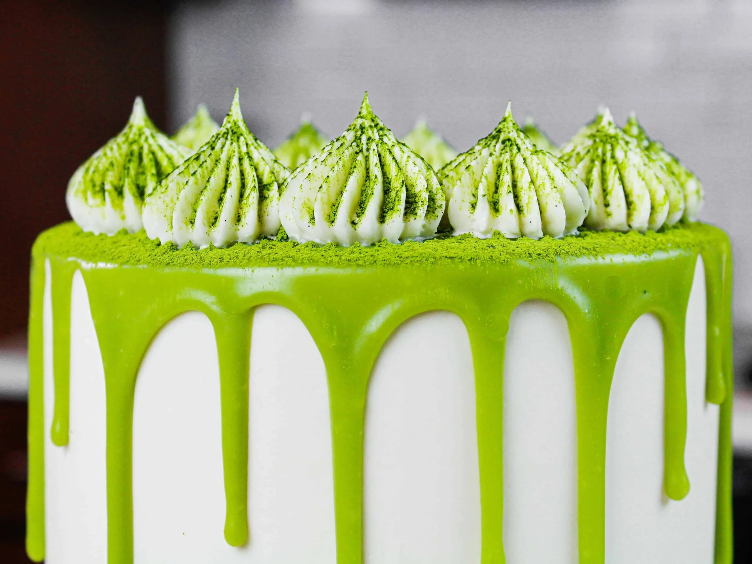 close up photo of a matcha cake, showing the frosting dollops piped with an ateco 869 frosting tip
