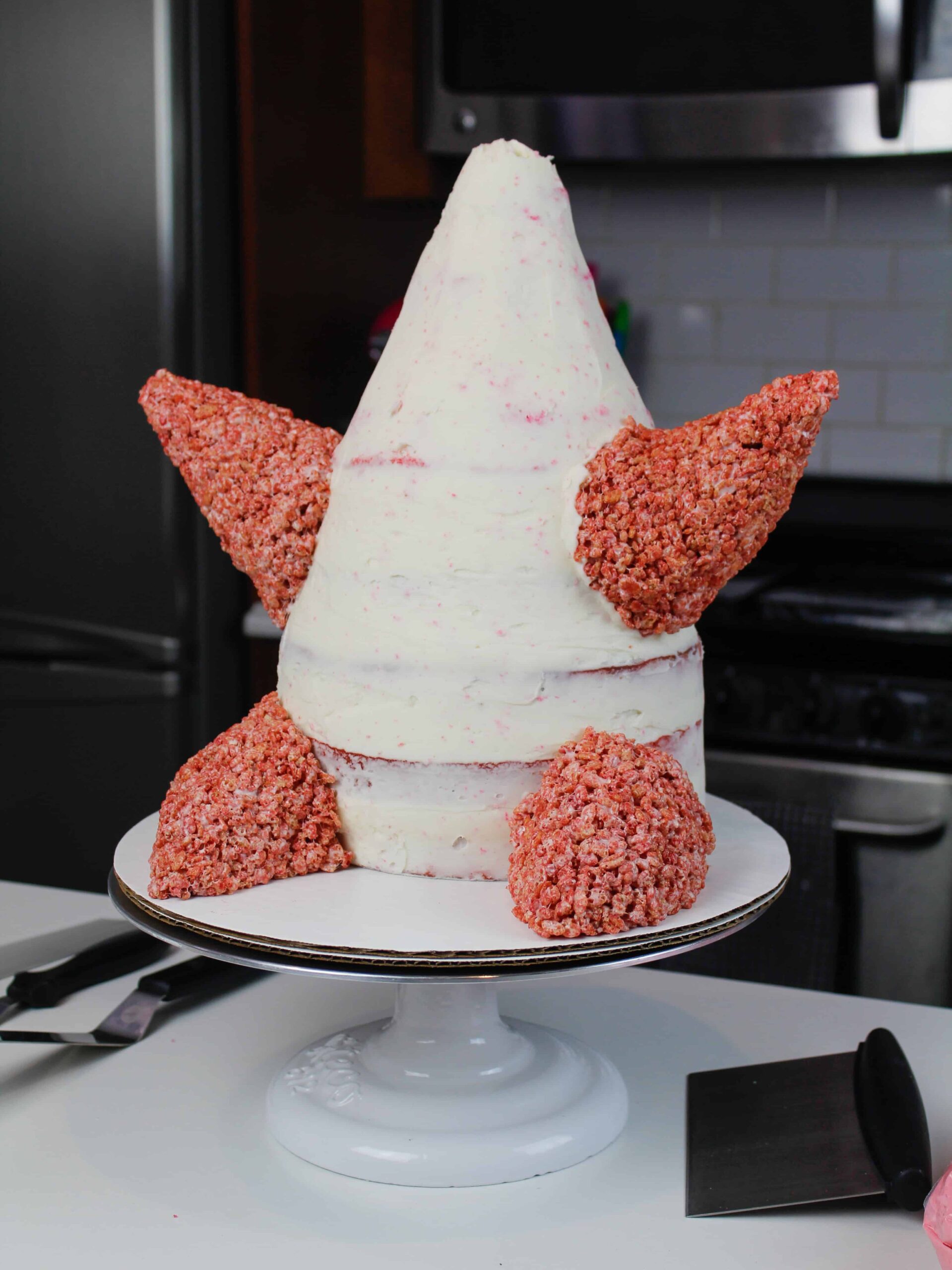 image of cake decorating rice krispies added to a patrick star cake to make his arms and legs