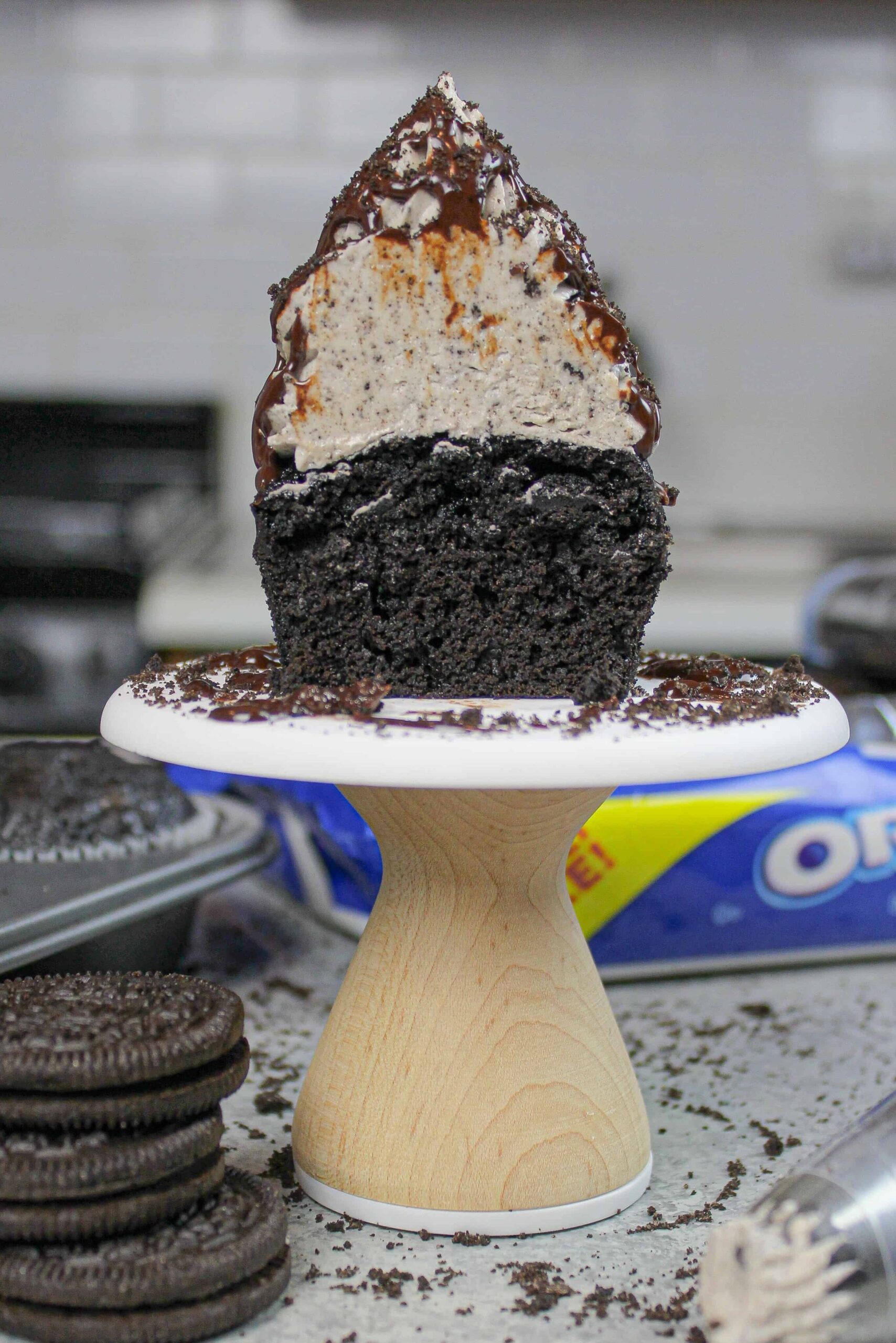 image of oreo cupcake, cut in half to show moist chocolate cupcake and oreo buttercream frosting