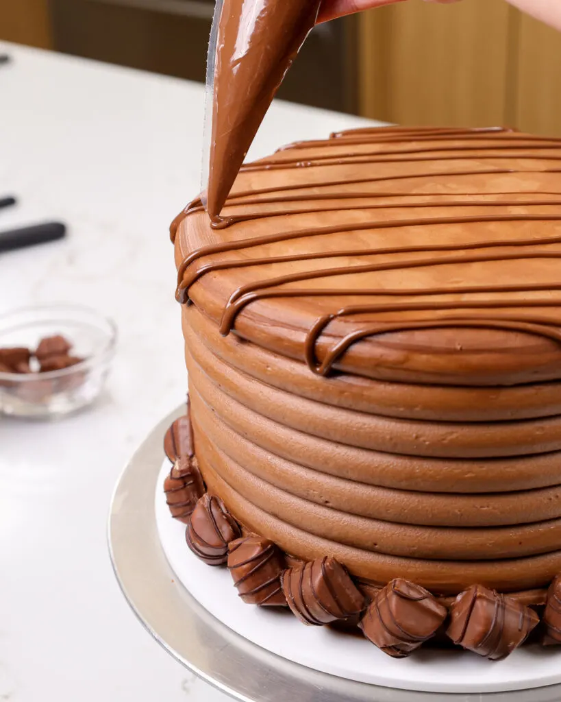 image of Nutella being drizzled over a kinder bueno cake