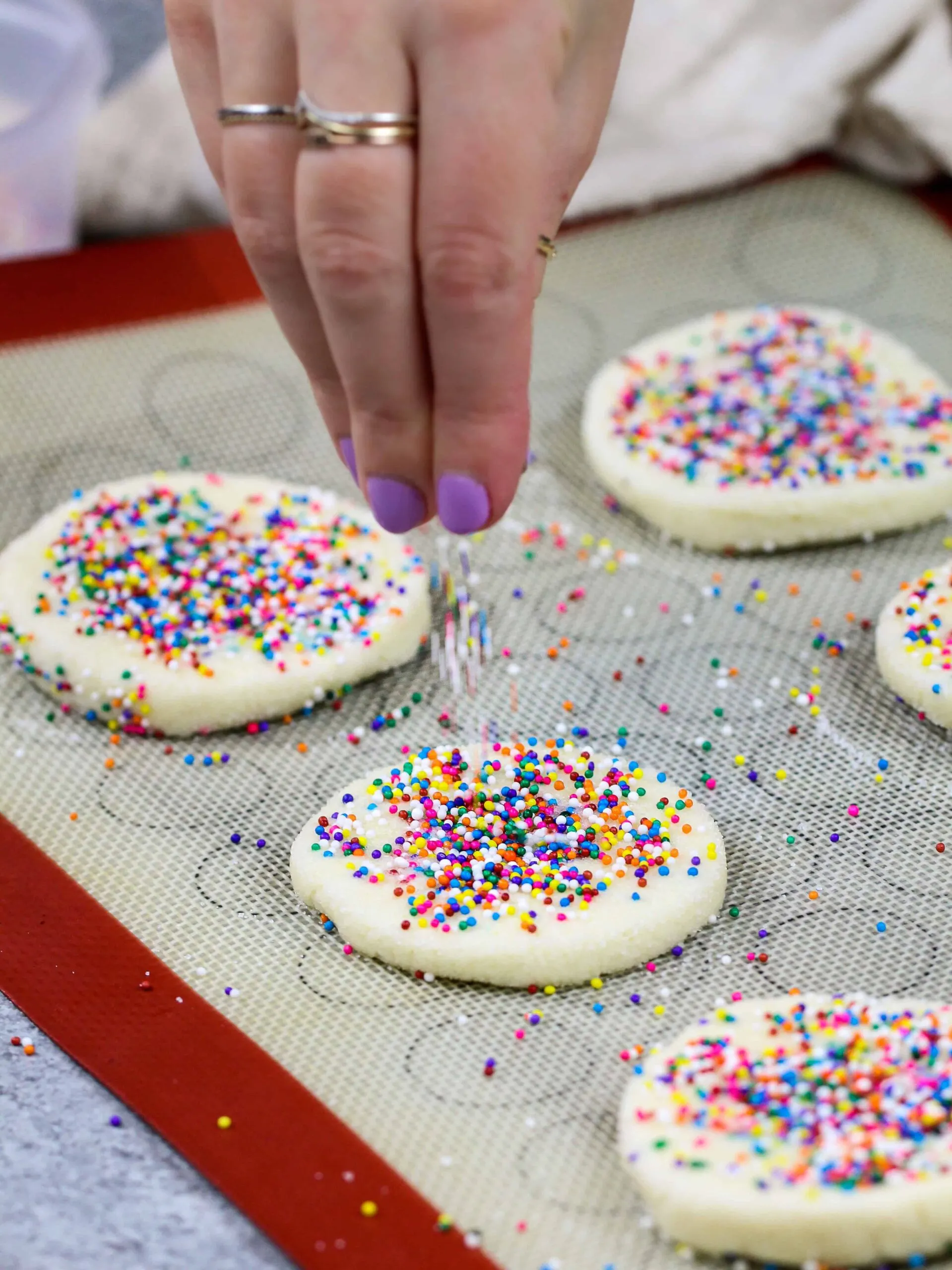 image of sprinkles being added on top of cream cheese shortbread cookies
