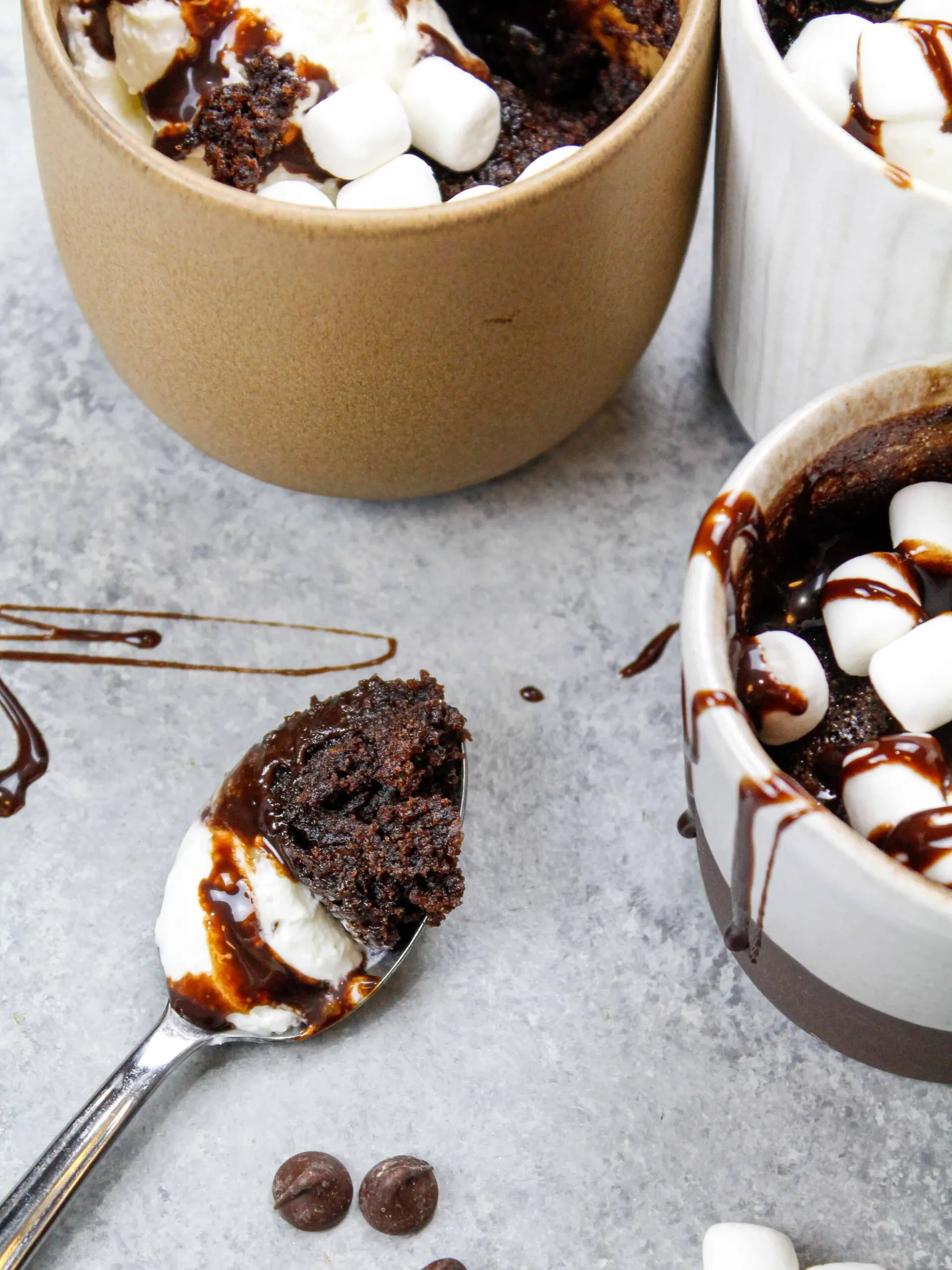 image of hot cocoa mug cake with spoonful scooped out to show how moist and fluffy the cake is