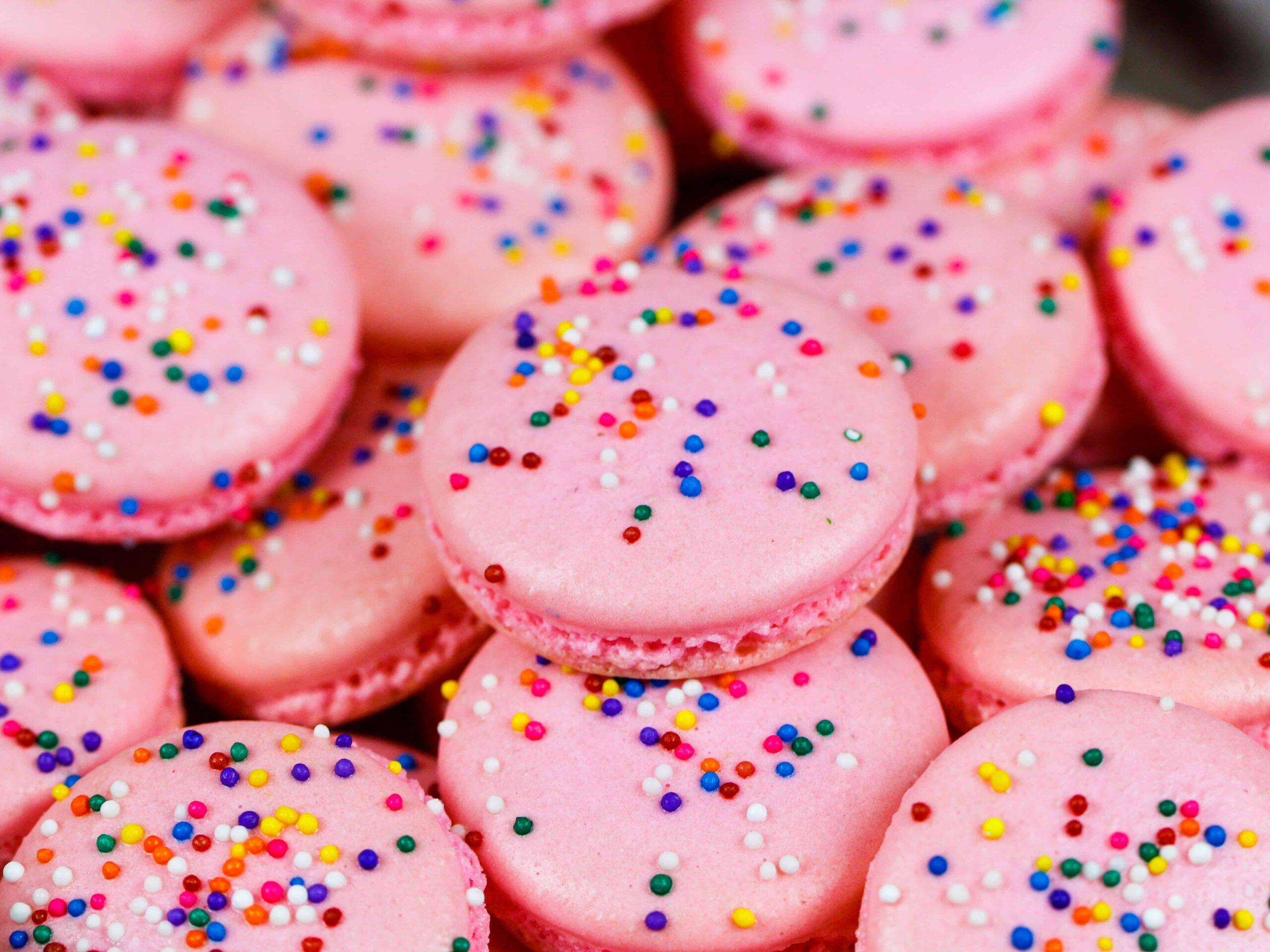 image of birthday cake macarons stacked on a plate