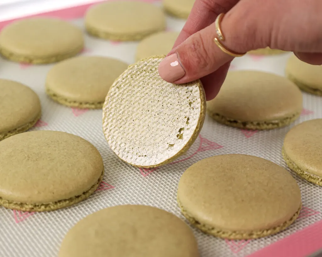 image of matcha macaron shells that have been properly baked and cleanly peel off the mat