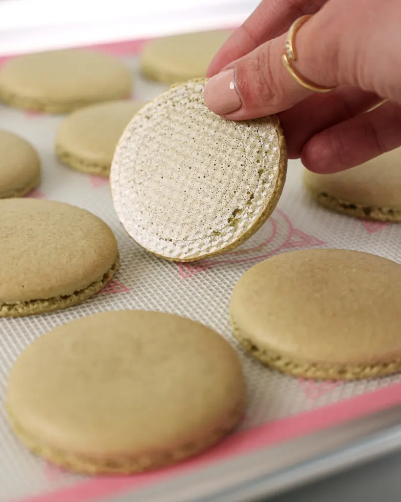 image of matcha macaron shells that have been properly baked and cleanly peel off the mat
