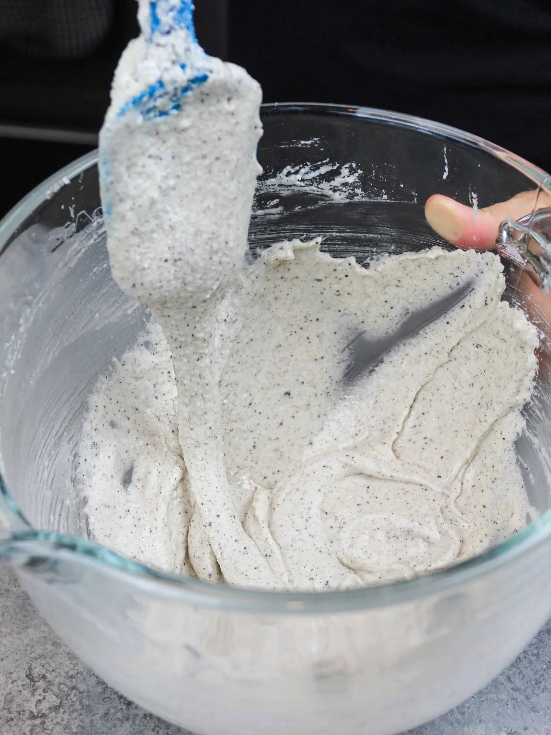 image of oreo macaron batter that's been mixed perfectly to have a thick lava or ribbon like consistency