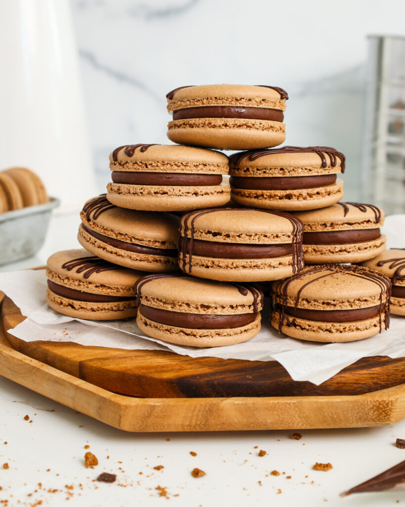 image of a french chocolate macaron being filled with a semi sweet chocolate ganache