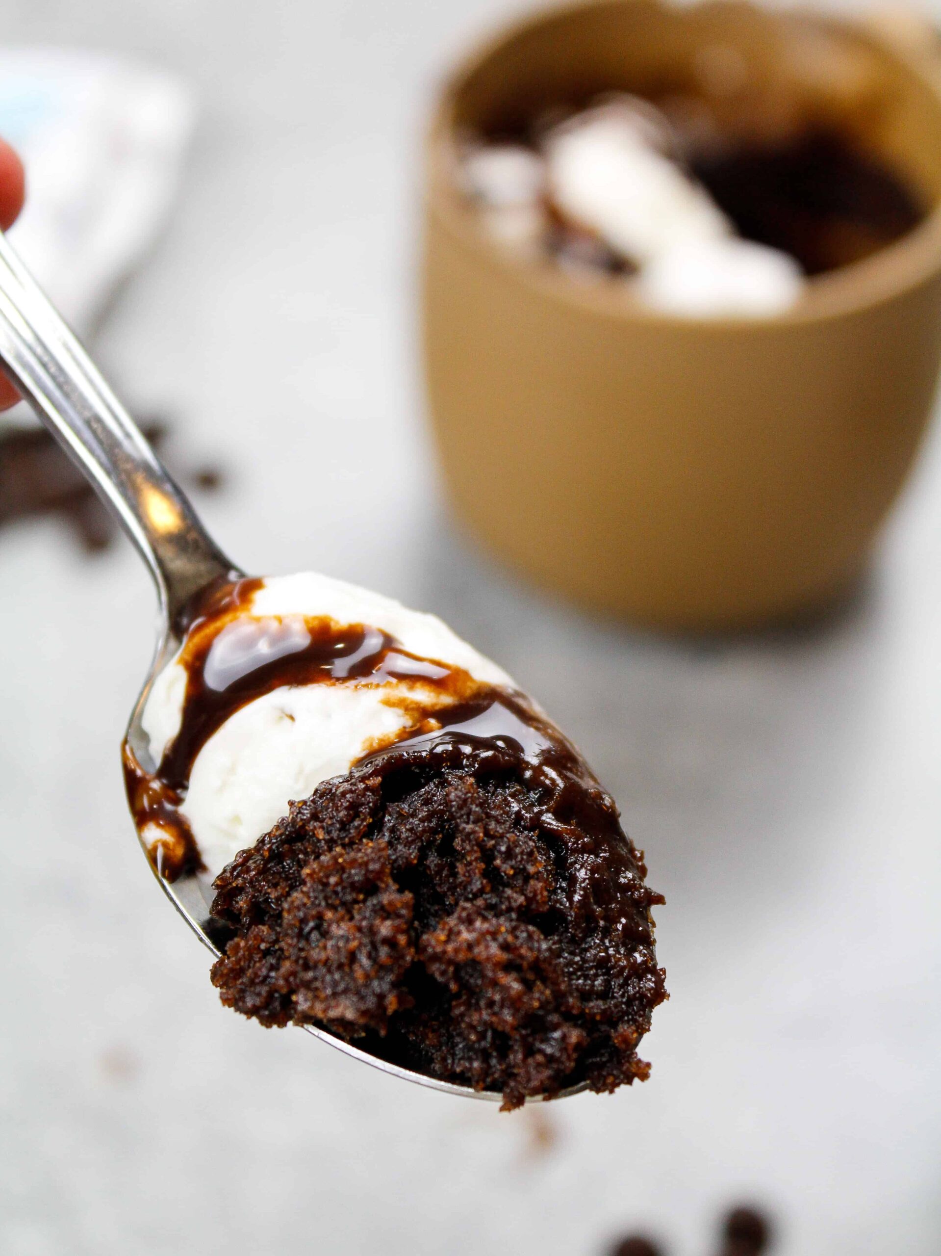 image of a spoonful of hot cocoa mug cake to show how delicious and chocolatey it is