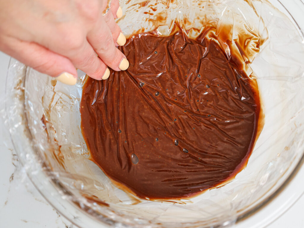 image of chocolate ganache filling for macarons that's been combined and is ready to be chilled in the fridge