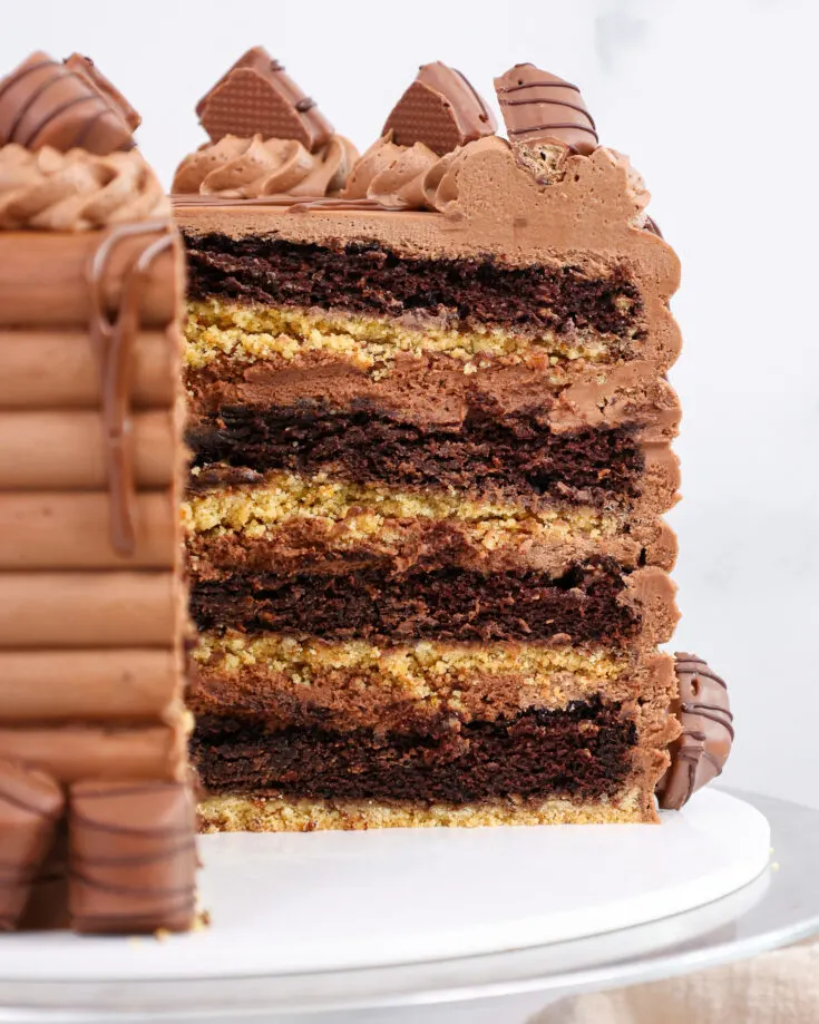 image of a kinder bueno cake that's been cut into to show it's hazelnut mousse filling and chocolate cake layers
