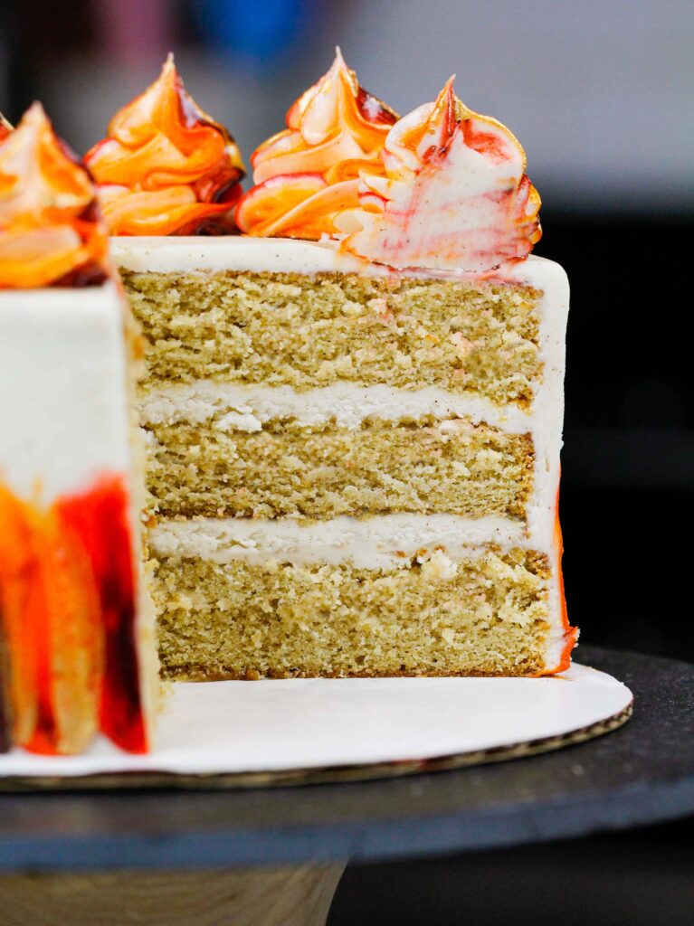 image of a gluten free layered spice cake that's frosted with a cinnamon cream cheese frosting