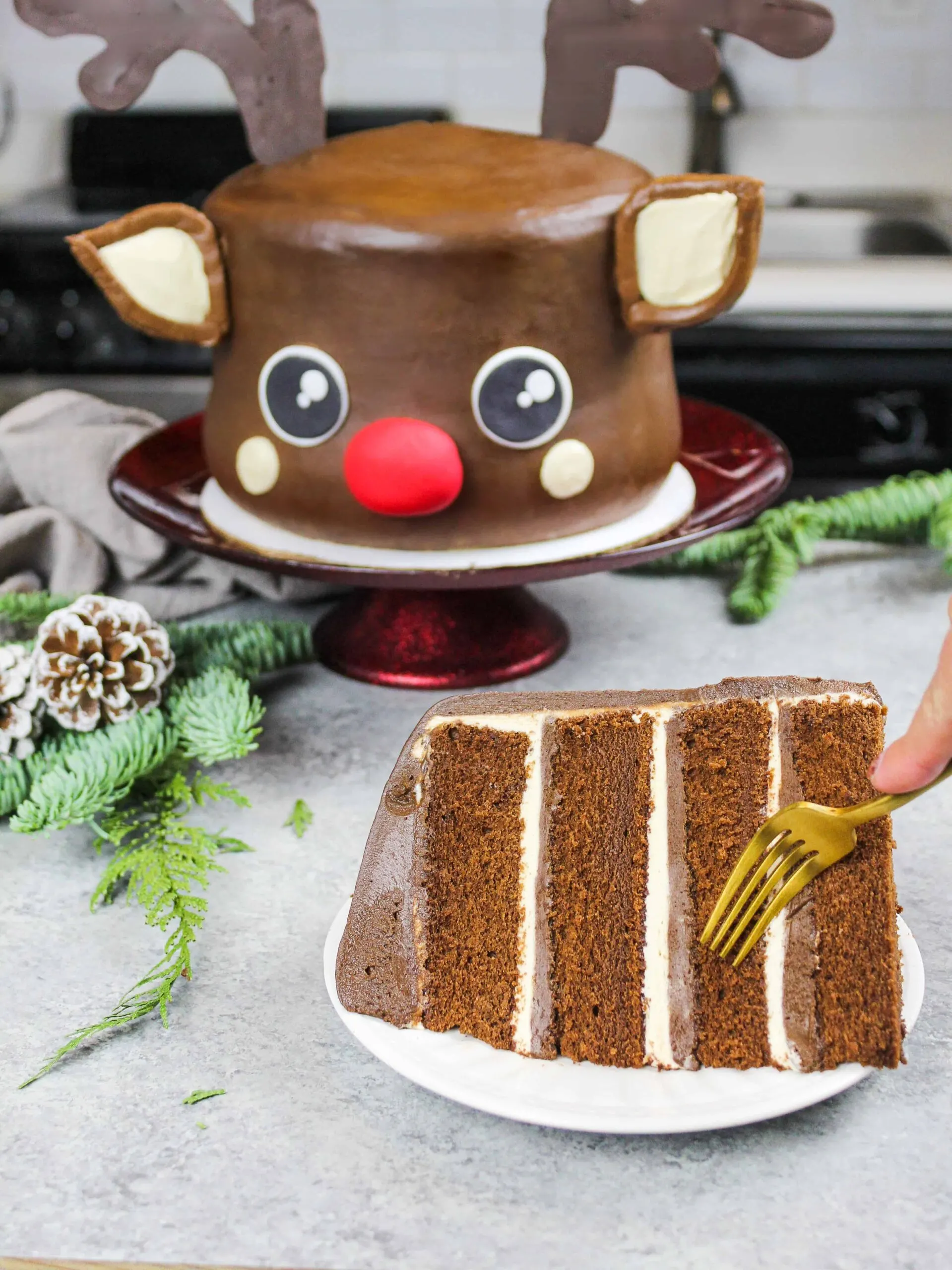 image of a chocolate peanut butter rudolph cake that's been cut into to show how moist and fluffy the cake layers are