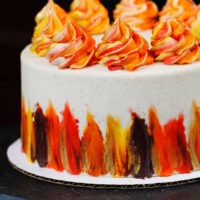 image of a beautiful gluten free spice cake decorated with bright Fall-inspired frosting