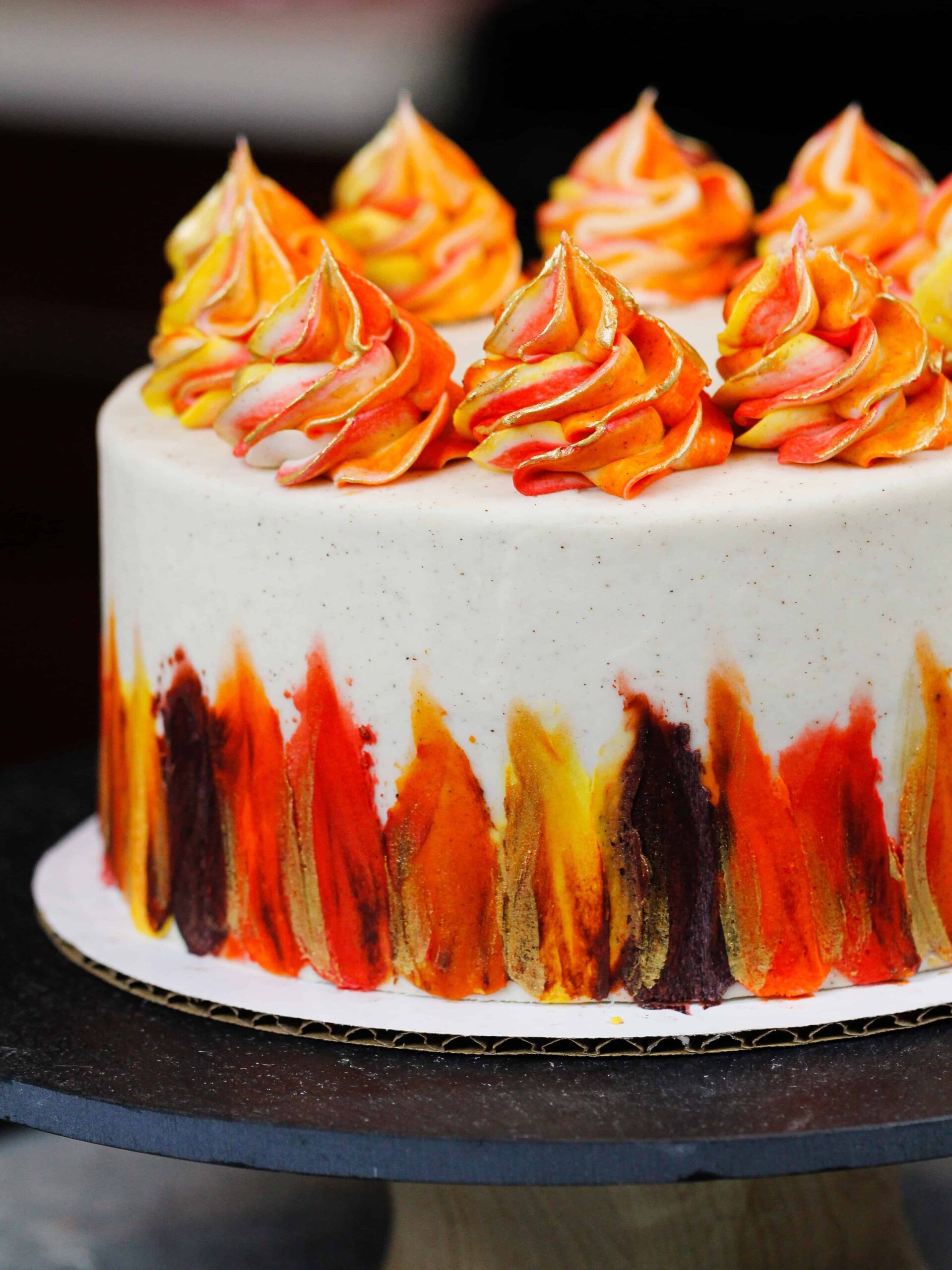 image of a beautiful gluten free spice cake decorated with bright Fall-inspired frosting