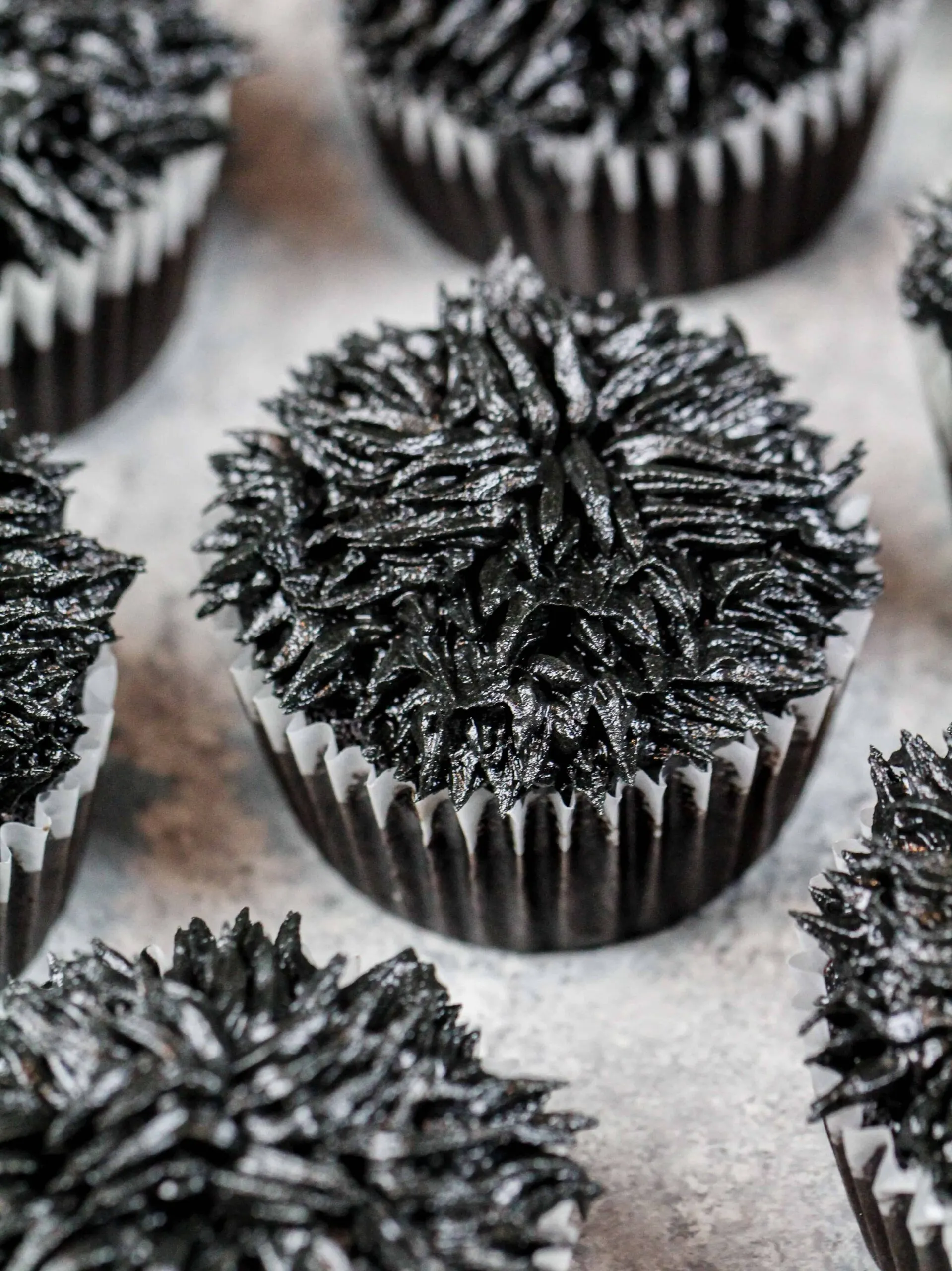 image of cupcakes frosted with black frosting using a grass tip to make soot sprite cupcakes