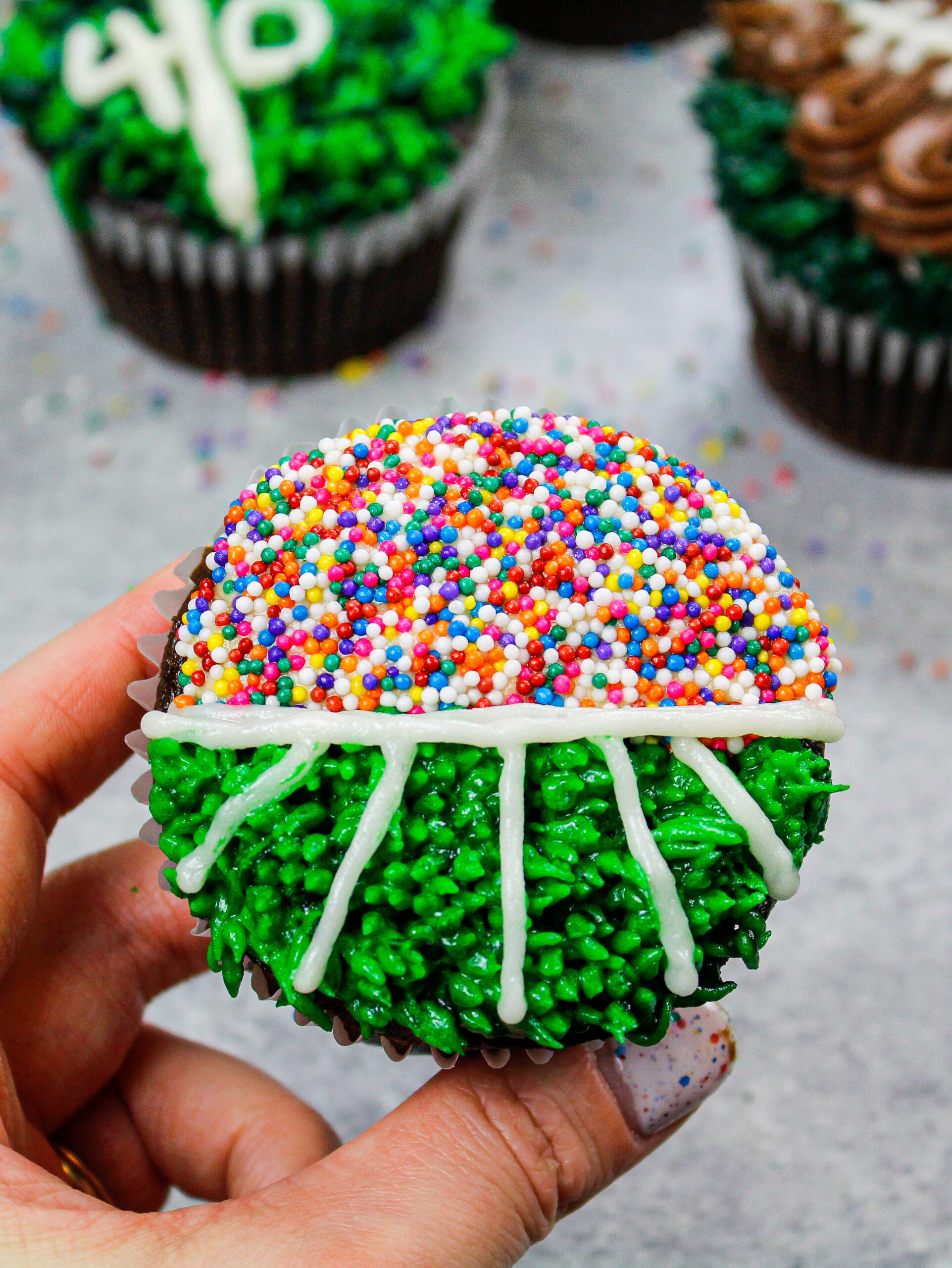 image of a football cupcake decorated to look like a football field with fans