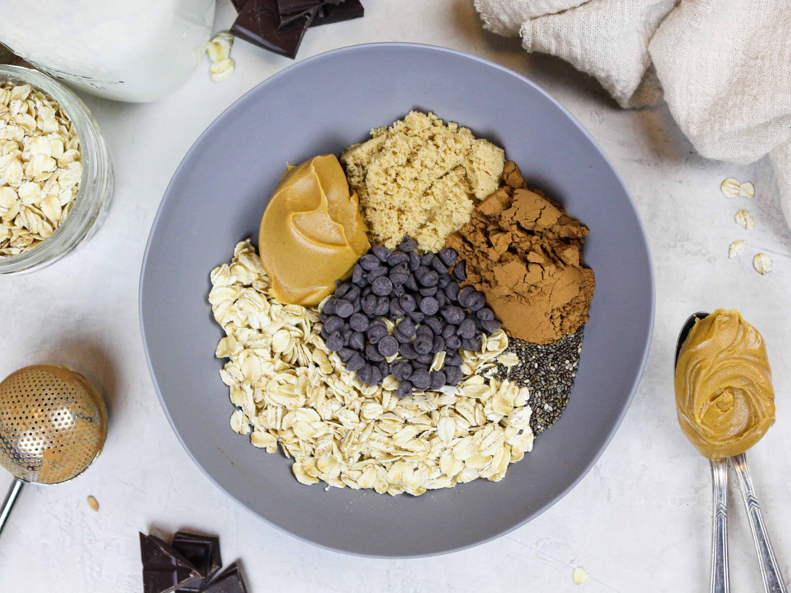 image of ingredients in a bowl to make chocolate peanut butter overnight oats