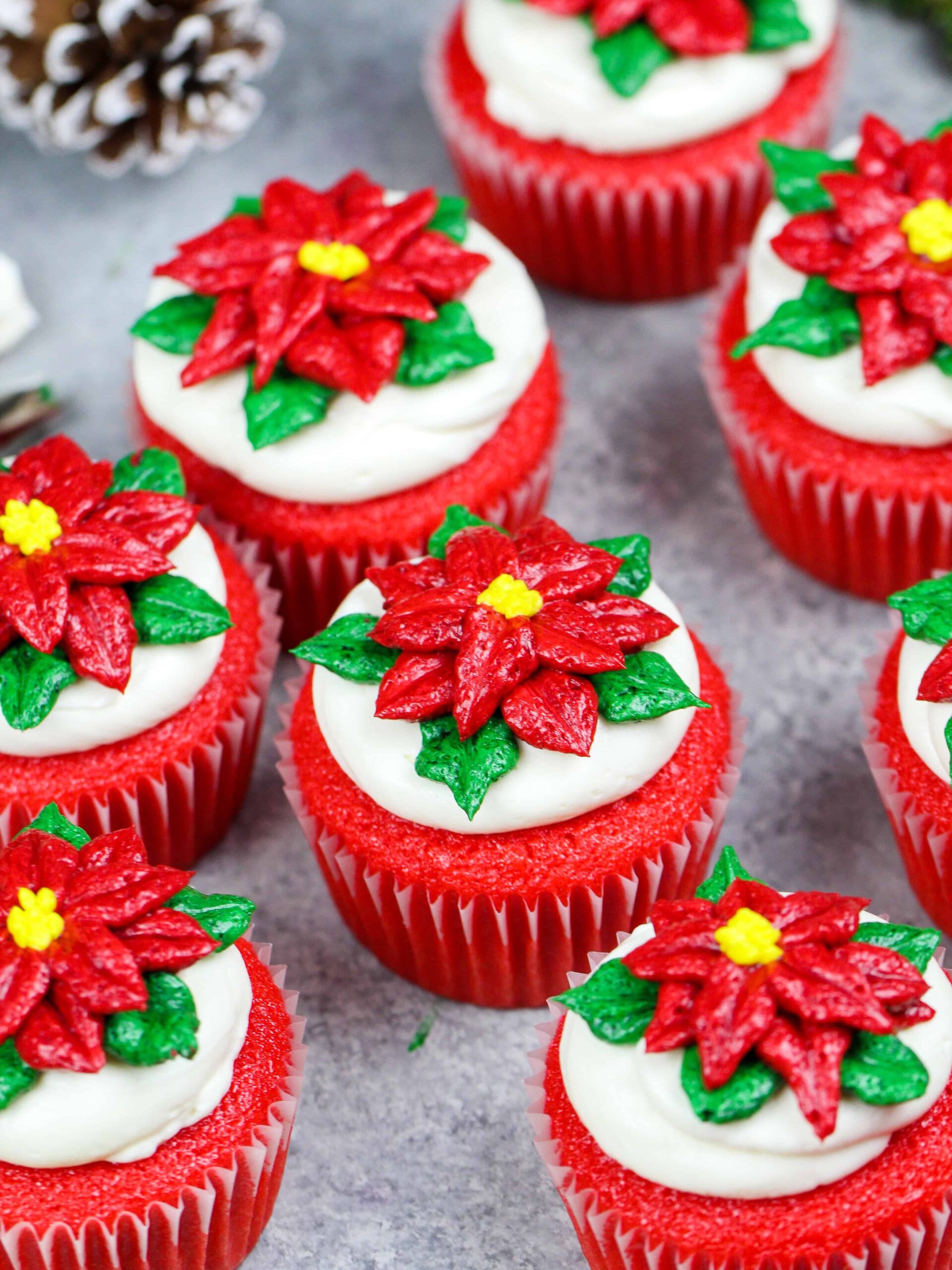 image of poinsettia cupcakes placed on a festive red cake stand