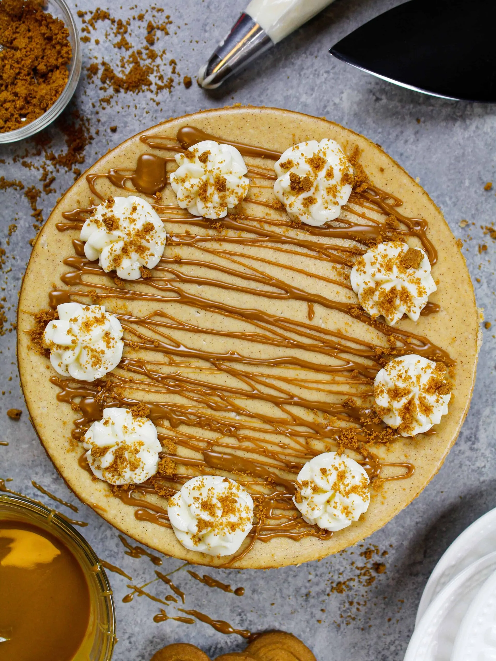 image of a biscoff cheesecake that's been decorated with biscoff cookie butter and whipped cream