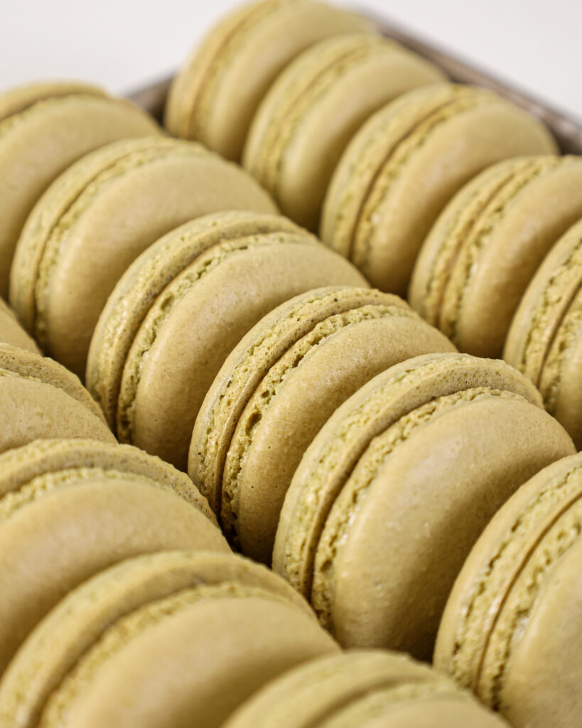 image of matcha macaron shells that have been paired together and are ready to be filled.