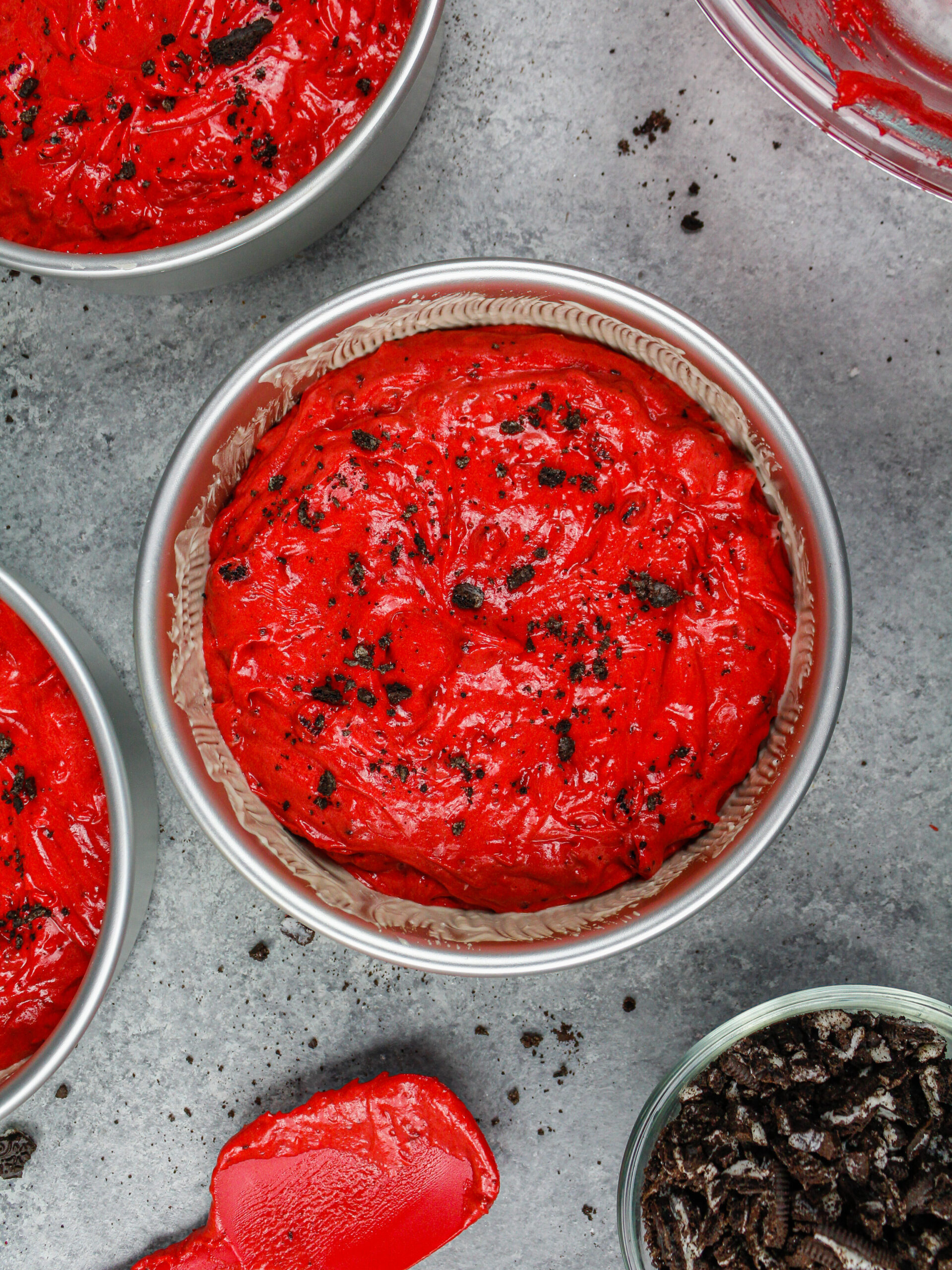 image of red velvet oreo cake batter in a 6-inch cake pan ready to be baked