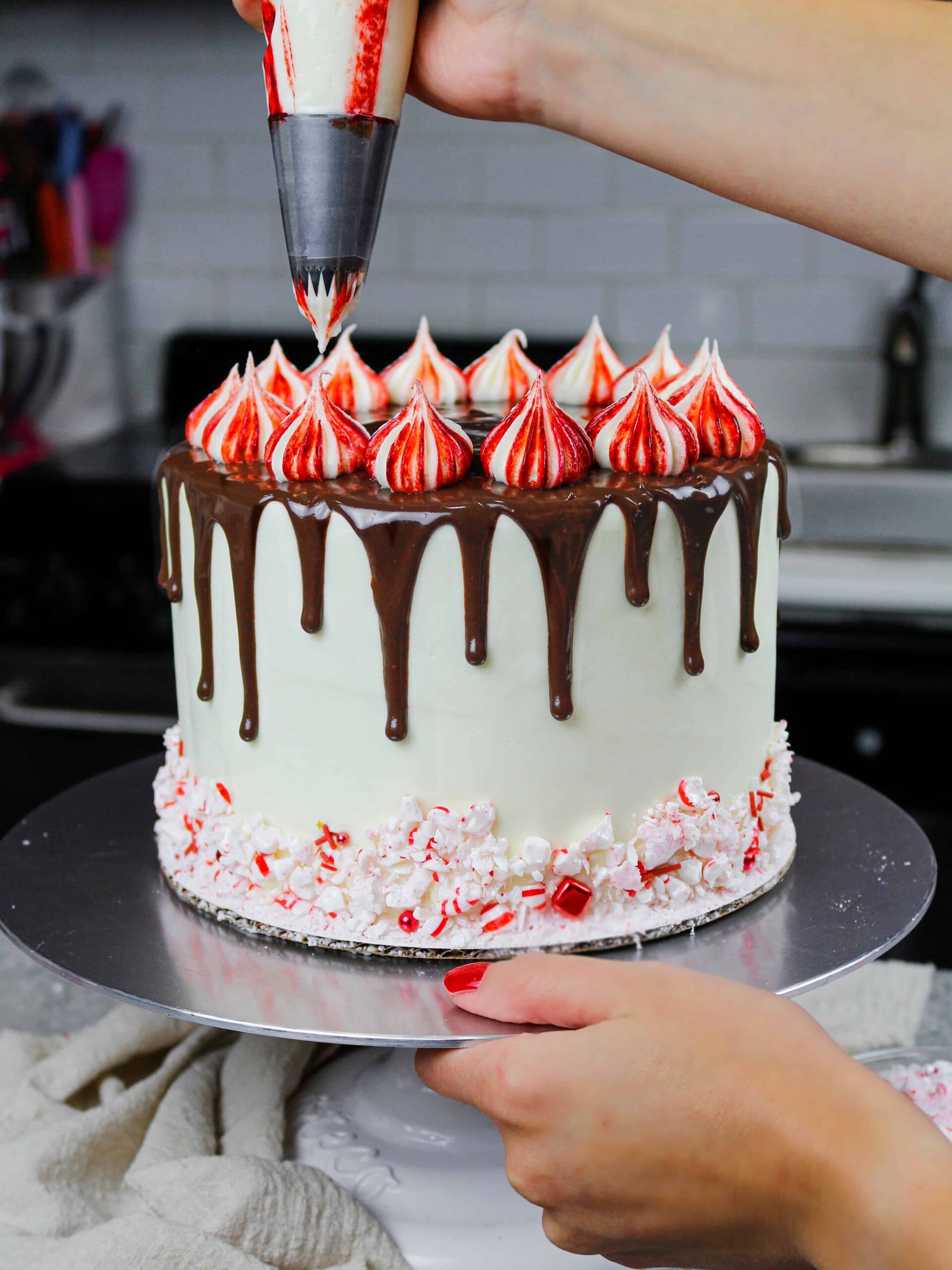 image of white chocolate peppermint frosting being piped onto a peppermint mocha cake