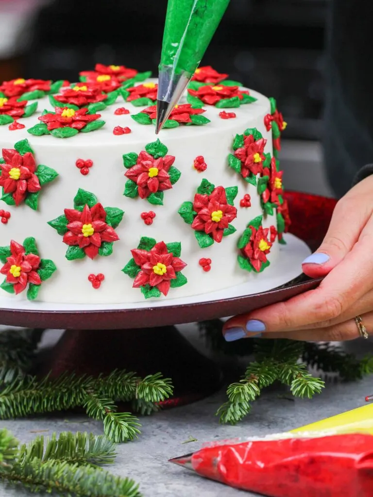 image of poinsettia cake made with red and green buttercream frosting