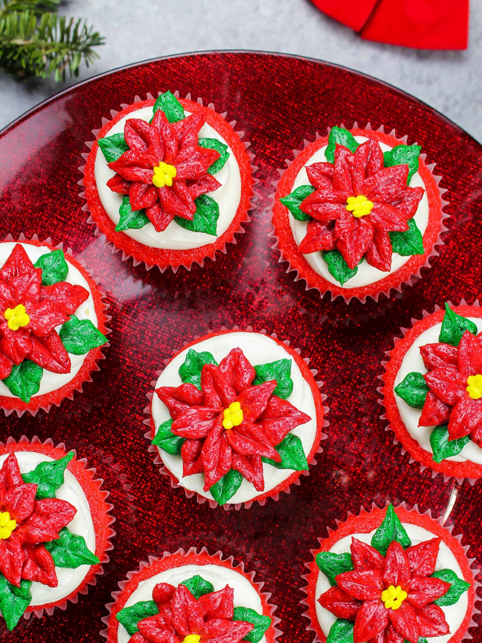 image of poinsettia cupcakes placed on a festive red cake stand