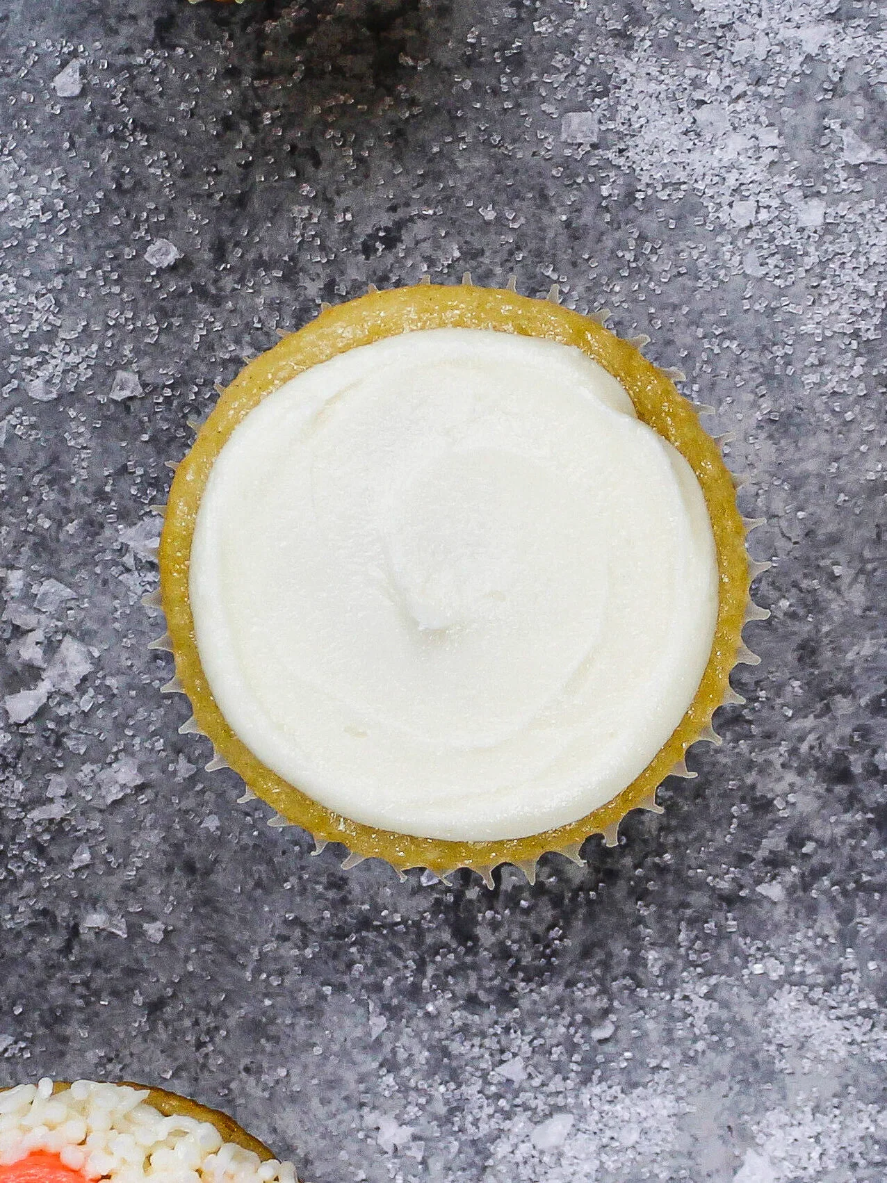 image of a cupcake covered in a thin layer of buttercream to make a polar bear cupcake