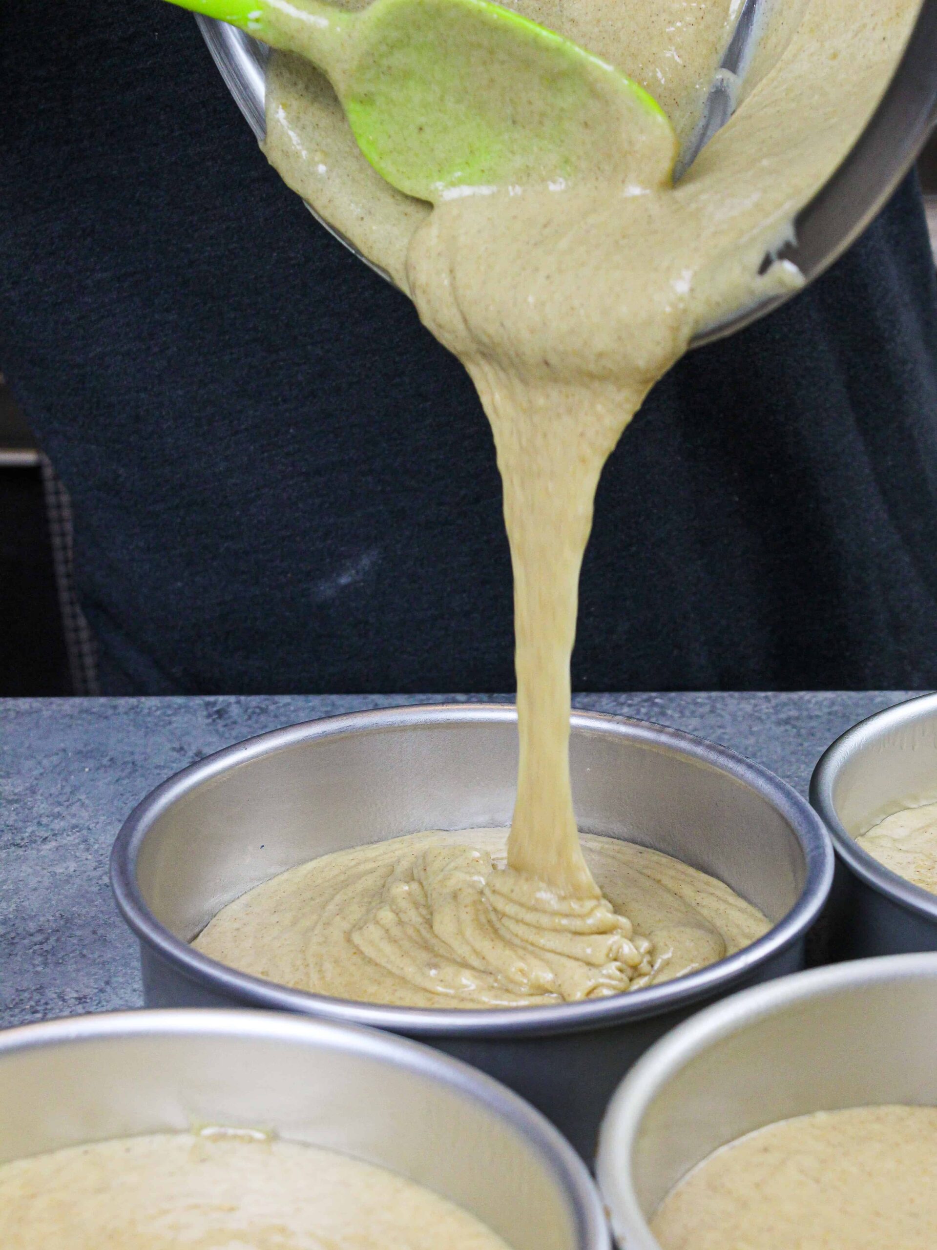 image of spice cake batter being poured into a greased cake pan