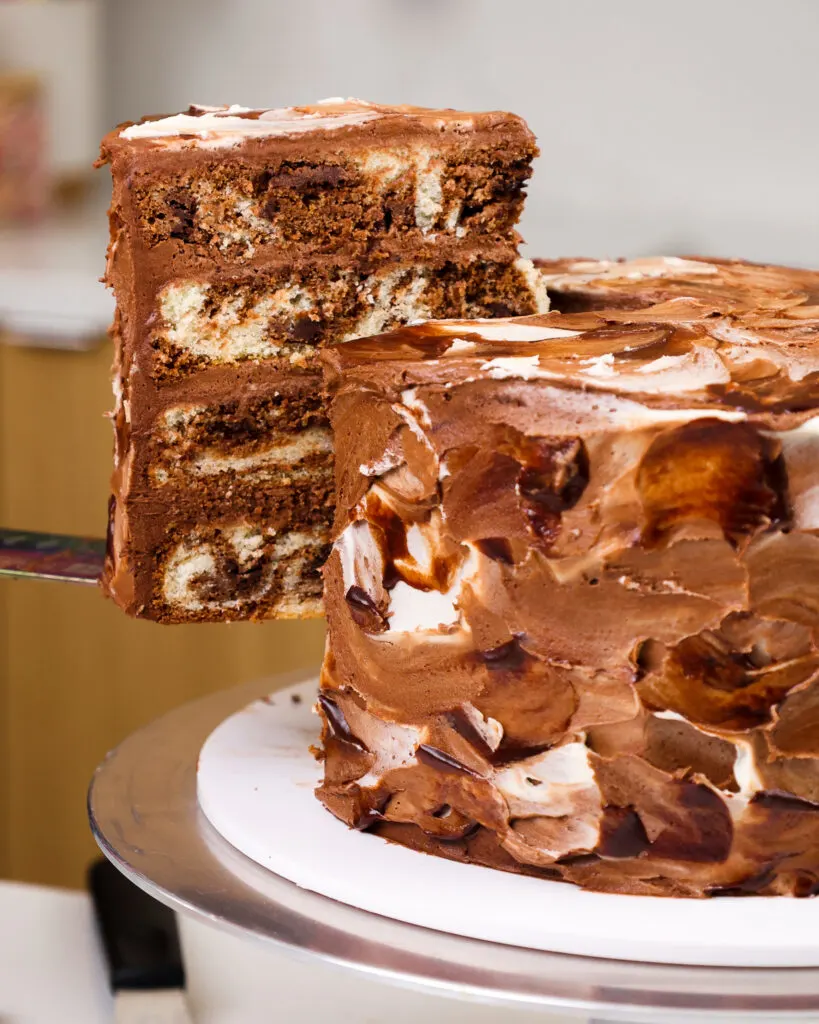 image of a slice of layered marble cake being cut and plated