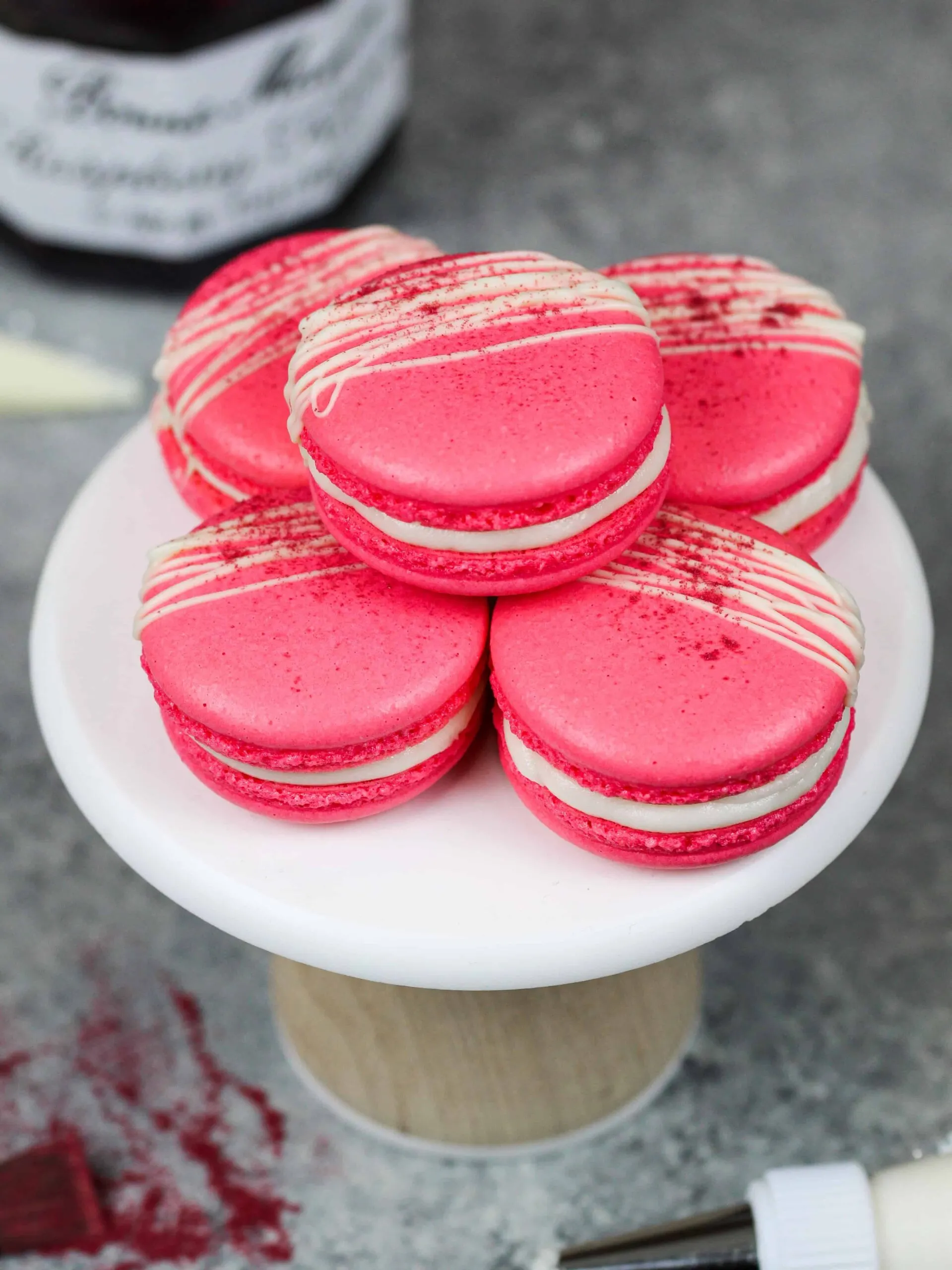image of raspberry macarons decorated with white chocolate and freeze dried raspberry powder