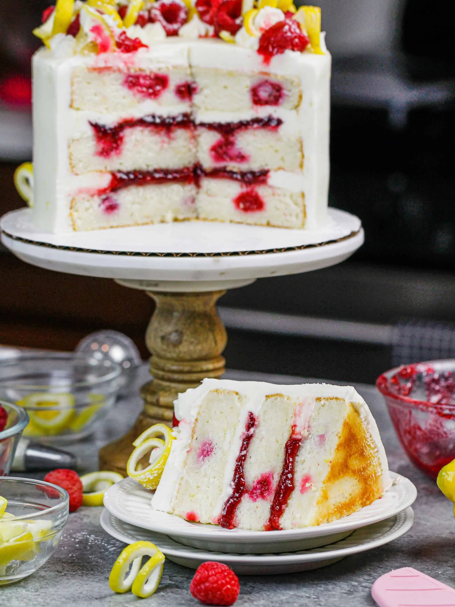 image of lemon raspberry cake slices open to show lemon cream cheese frosting and raspberry filling