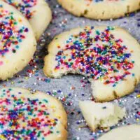 image of cream cheese shortbread cookies topped with nonpareil sprinkles