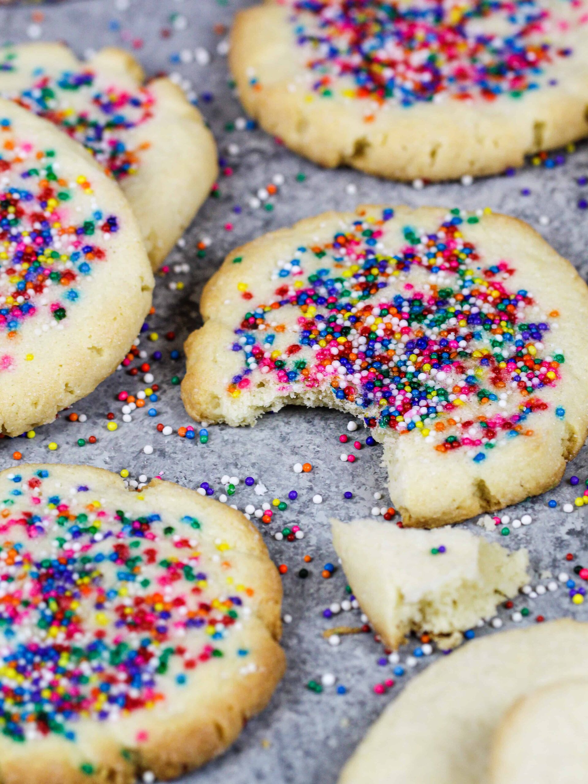 image of cream cheese shortbread cookies that have been sprinkled with non pareil spinkles