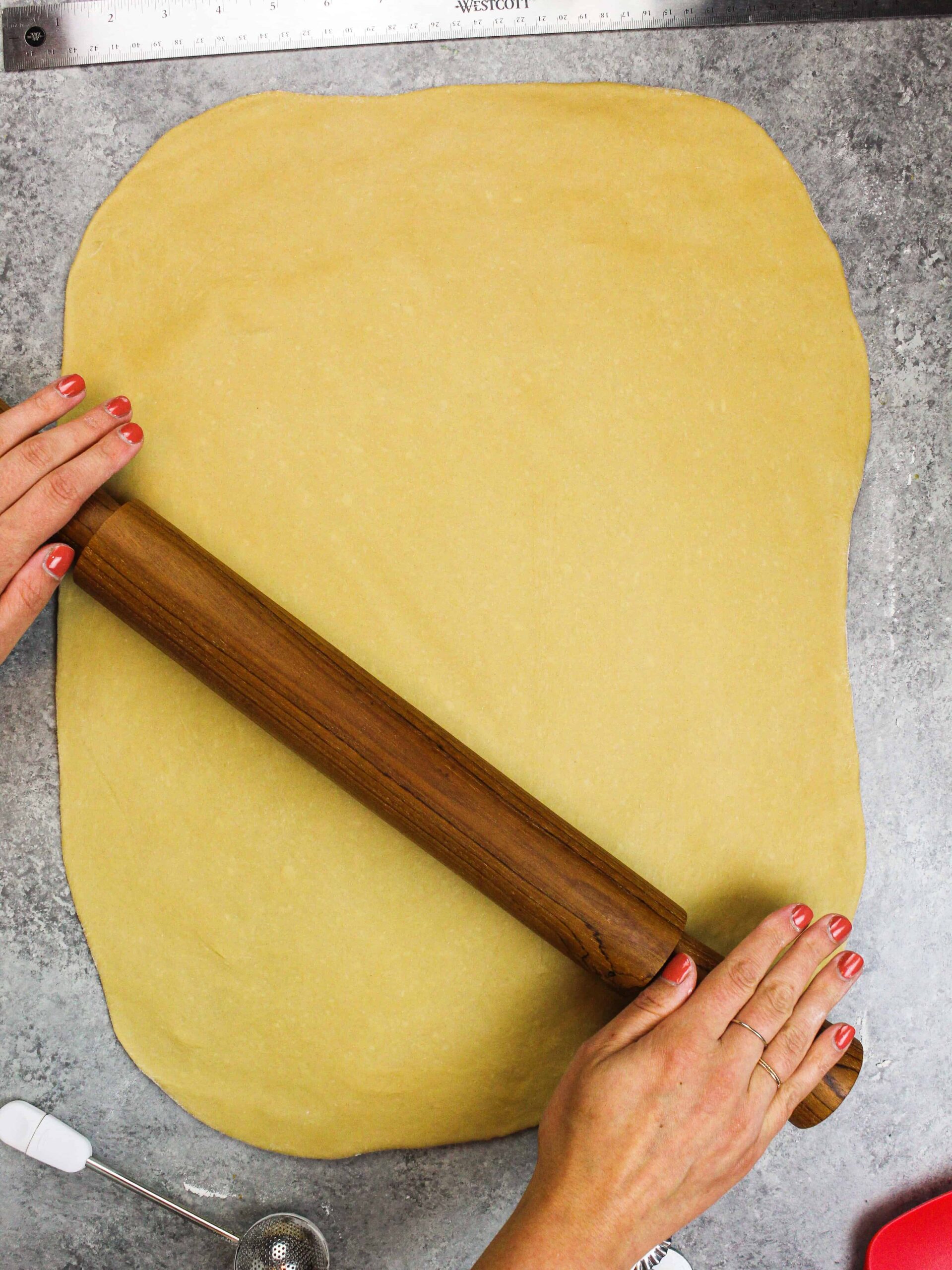 image of coffee flavored dough being rolled out on a floured surface.
