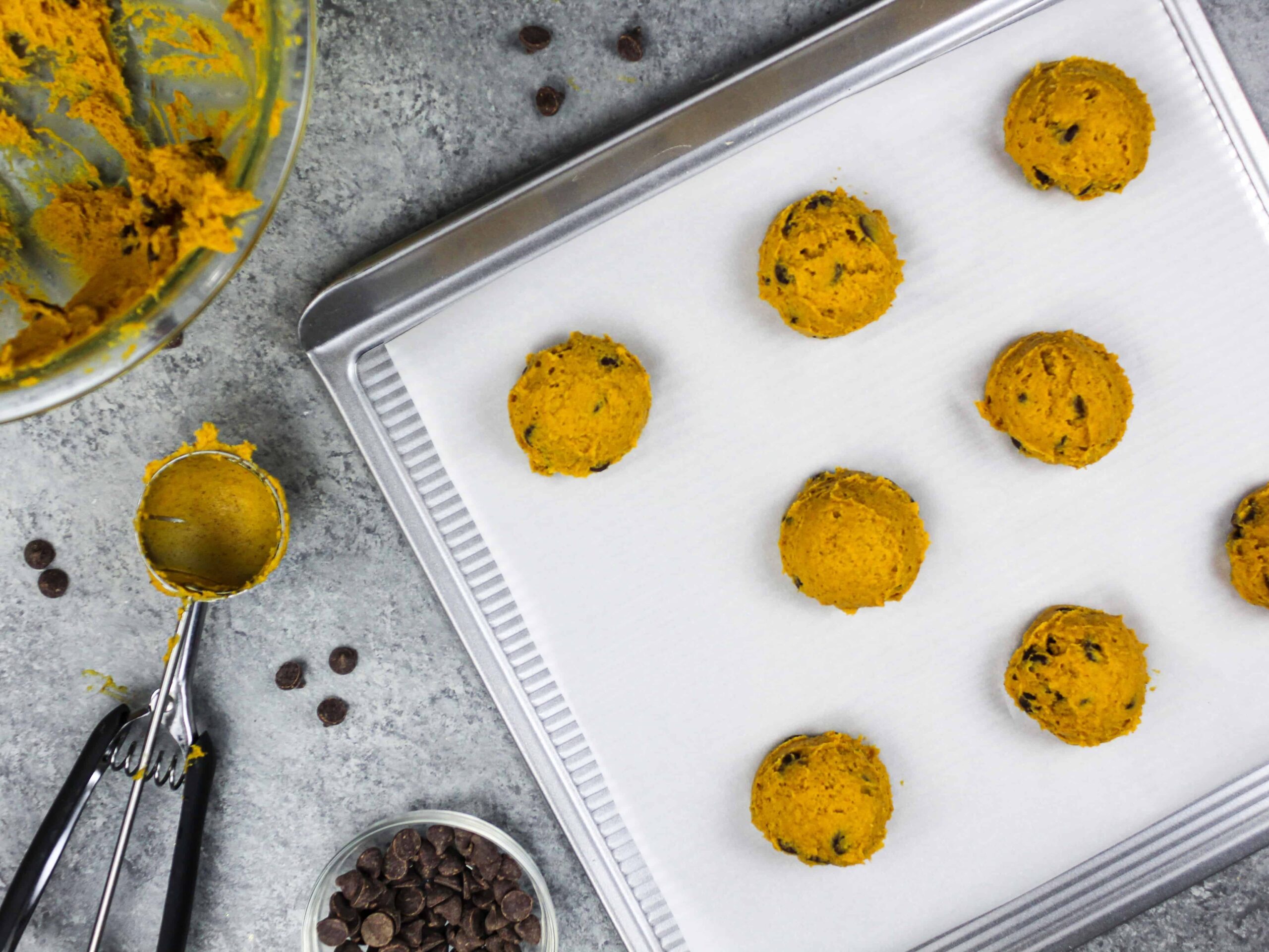 image of vegan chocolate chip pumpkin cookies that are scooped and ready to be baked