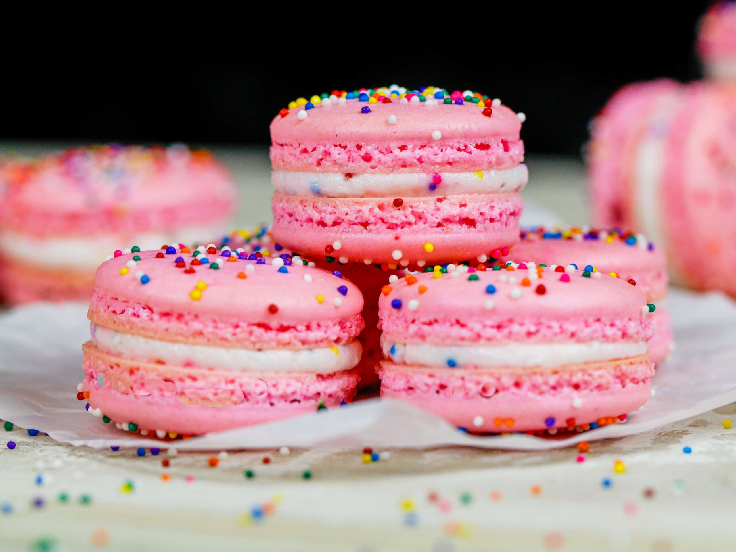 image of birthday cake macarons that are filled with sprinkle birthday cake frosting