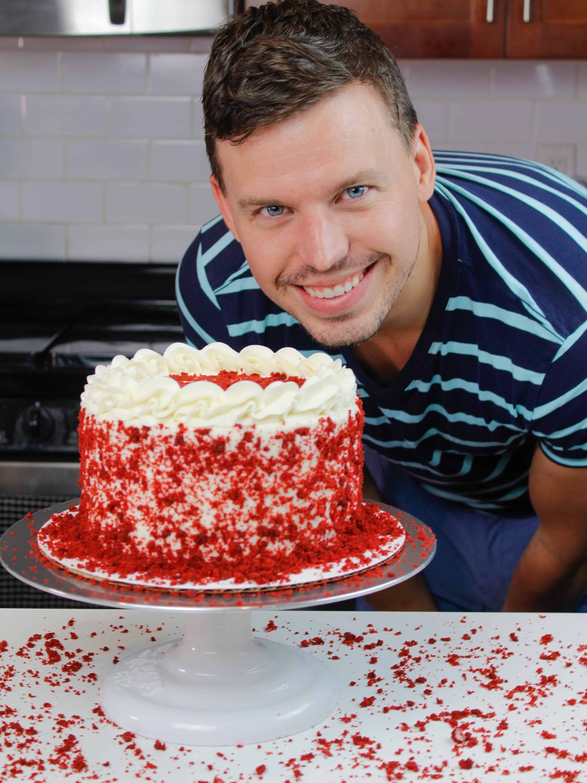 image of happy husband with red velvet layer cake