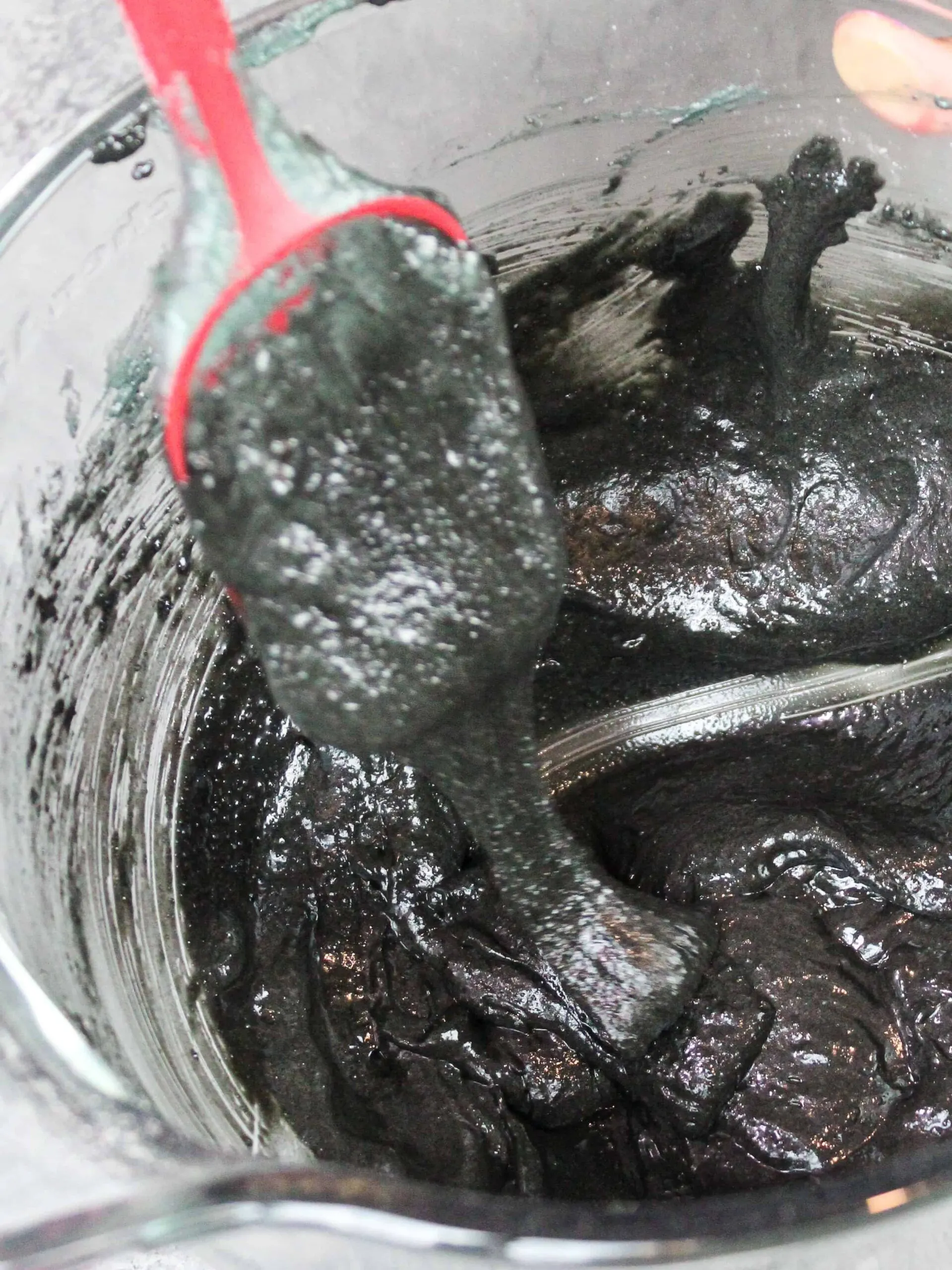 image of black macaron batter that's been mixed to the perfect consistency