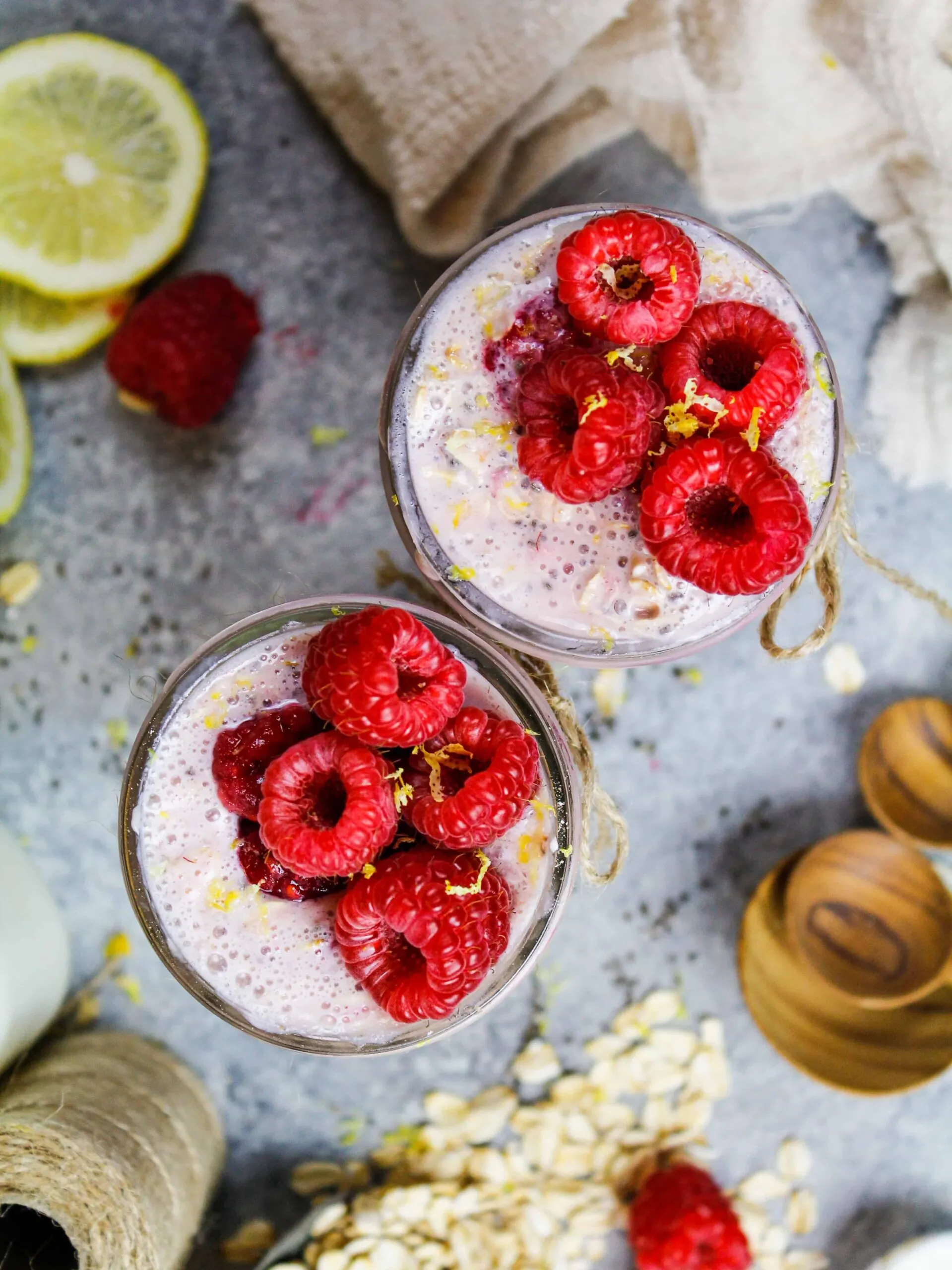 image of raspberry overnight oats that are topped with fresh raspberries and lemon zest