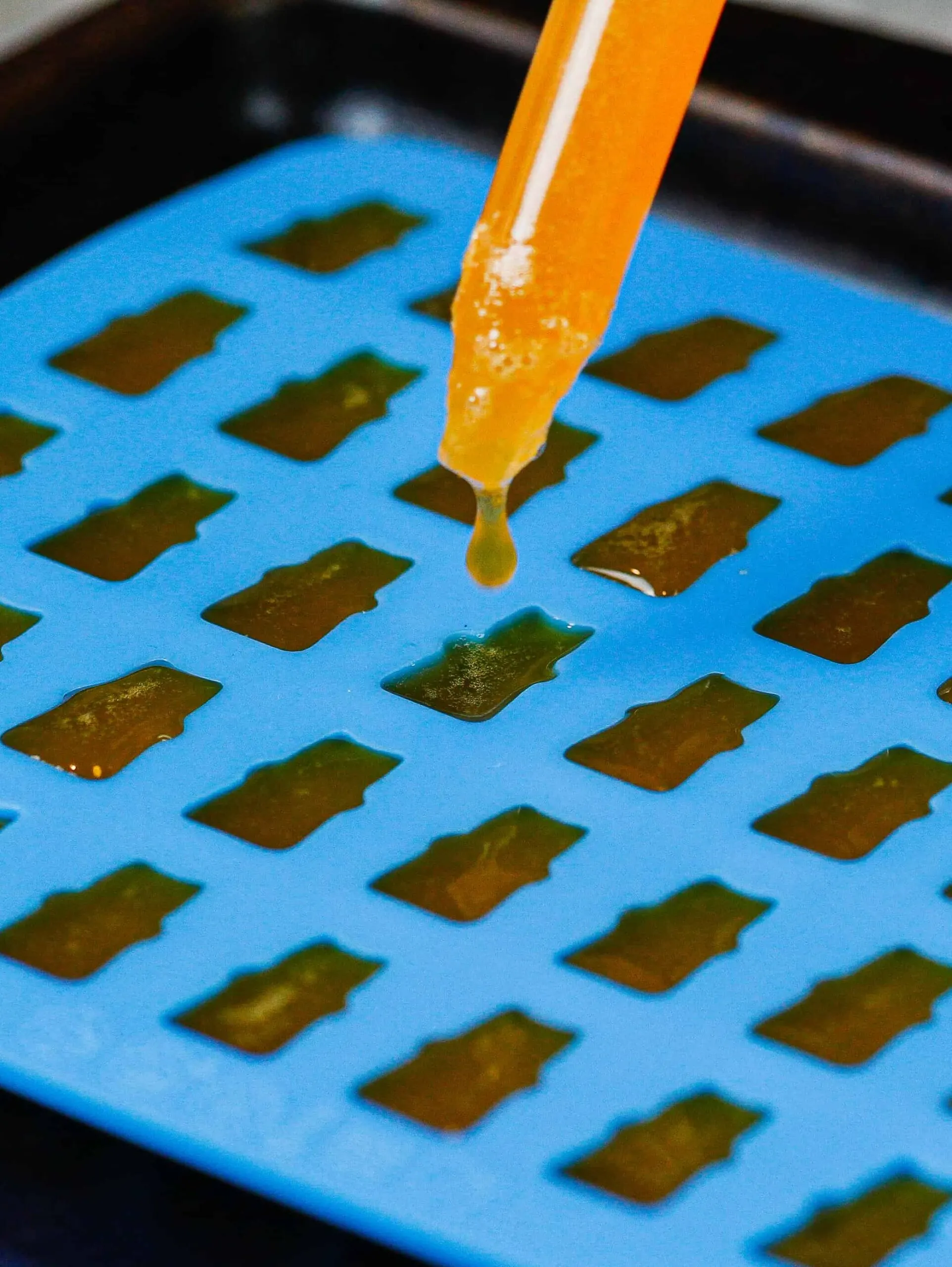 image of a silicone mold being filled to make DIY gummy bears